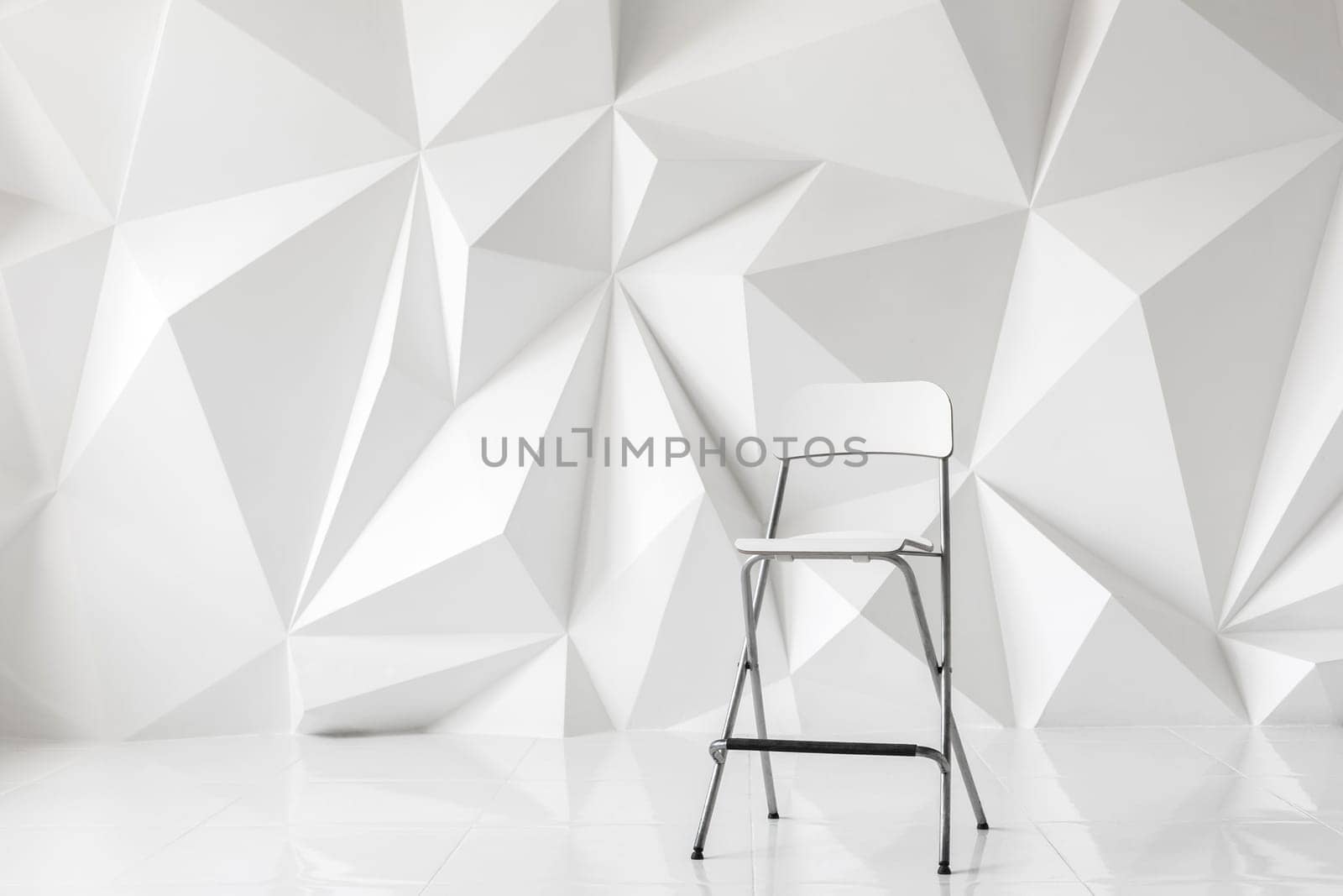 Modern chair on abstract background of polygons on white background. White texture.