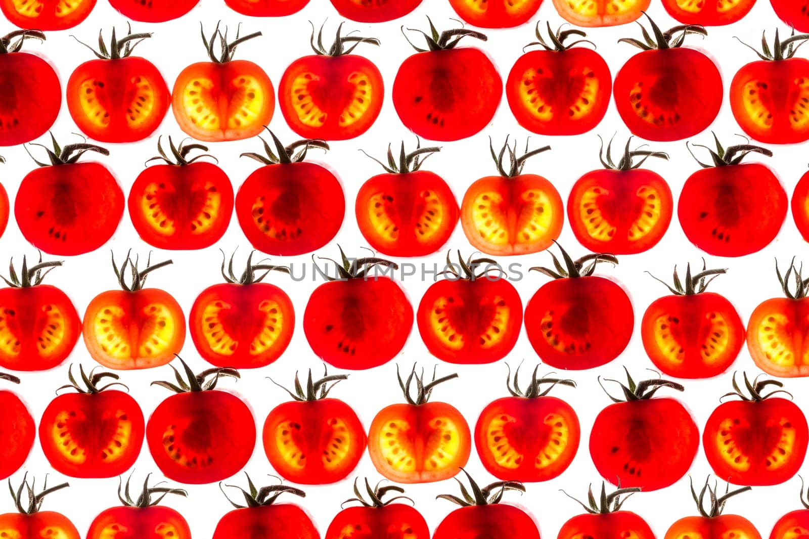 many tomato slice backlit showing intricate detail red green pattern