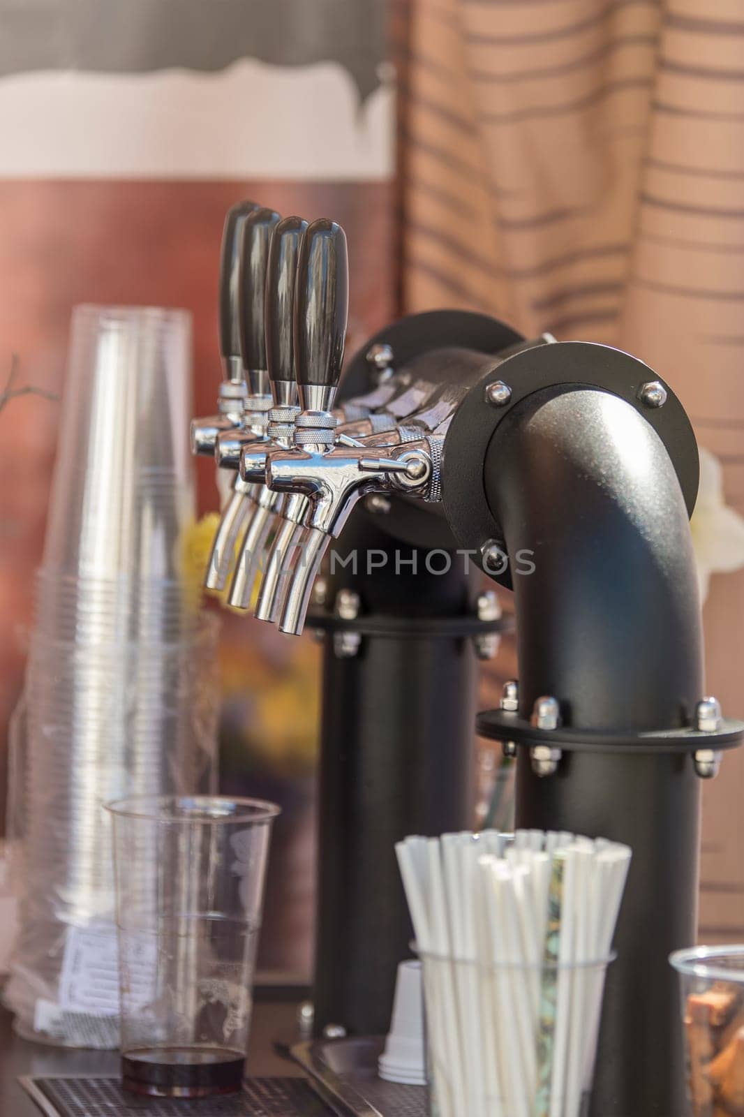 Handmade beer faucet. Bar counter in a pub with a beer tap, side view. The concept of buying, selling and drinking beer. High quality photo