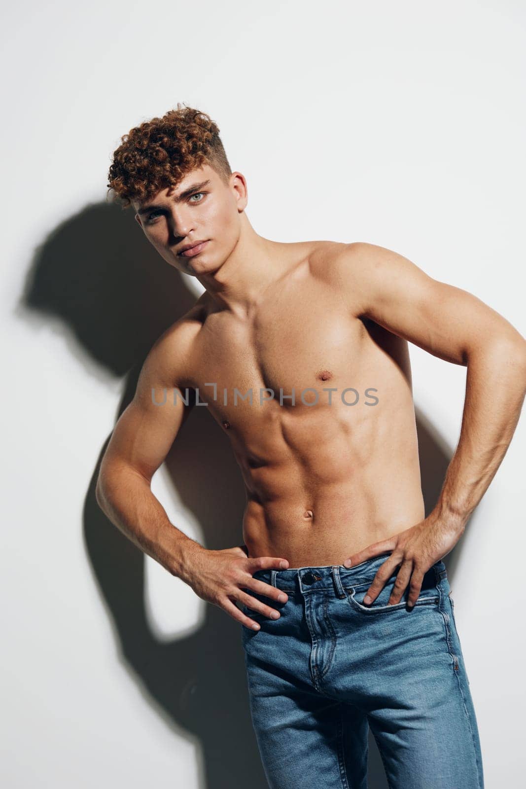 man abs fit standing athlete background attractive jeans person gray shirtless smile by SHOTPRIME