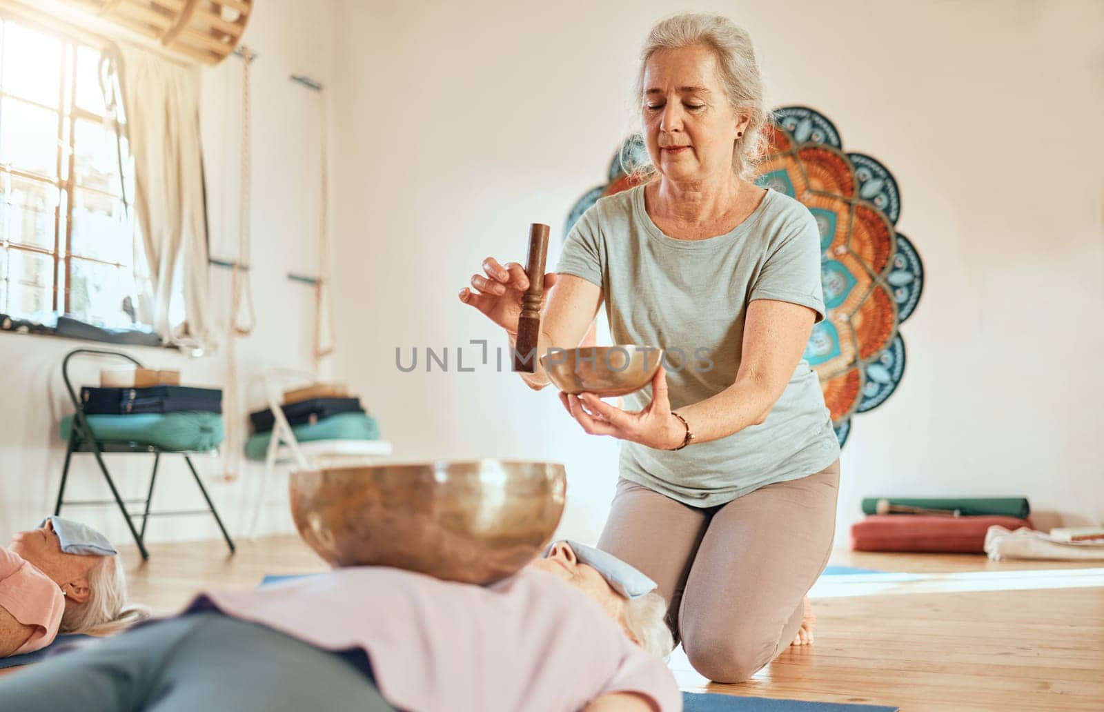 Meditation, tibetan bowl and zen senior women doing a sound healing or therapy practice in a studio. Peace, calm and elderly friends with a singing bowl for body and mind wellness, health and balance.