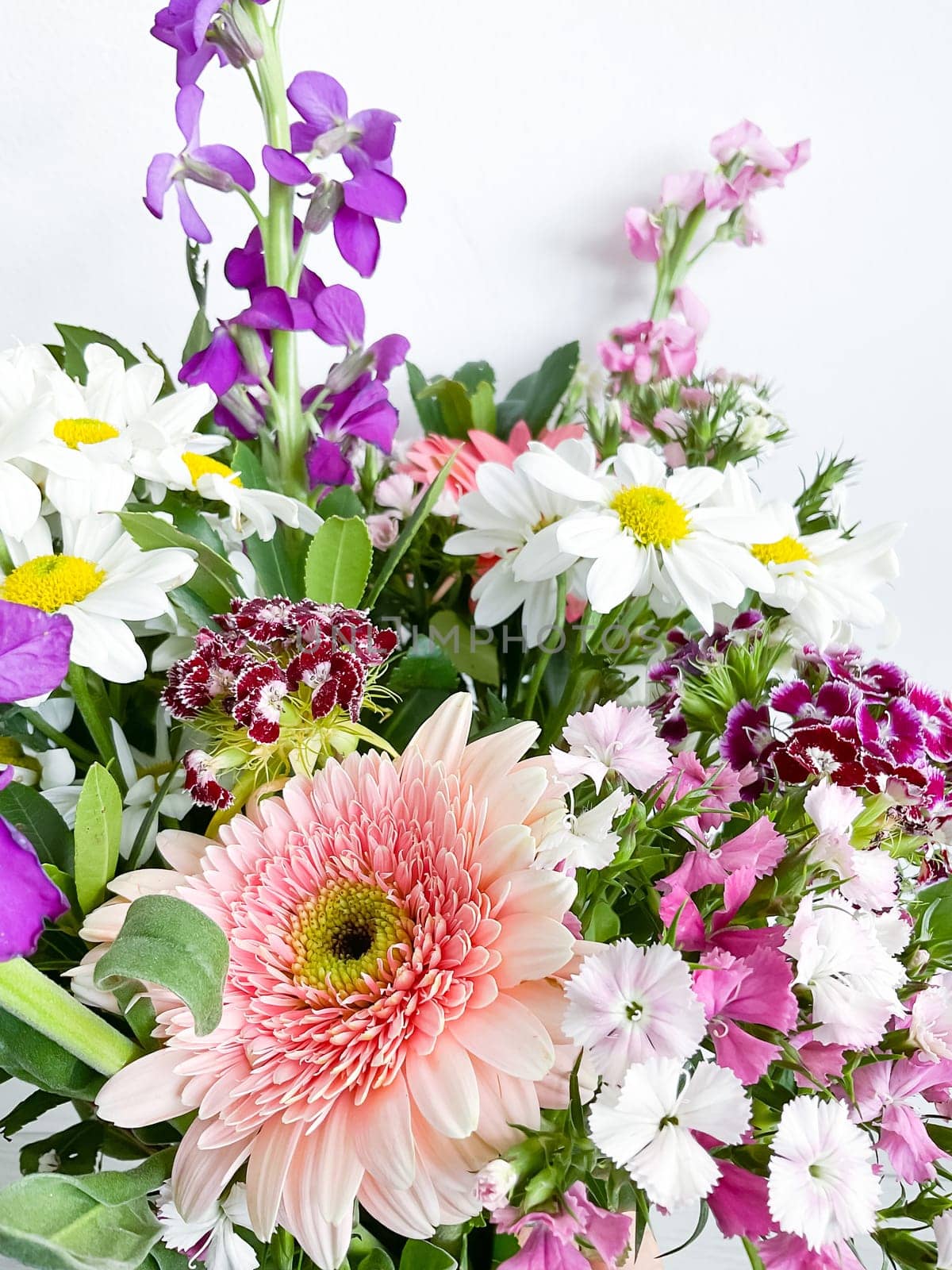 bouquet of flowers. japanese dianthus, gerbera, matthiola, chamomile and laurel leaves. flower composition. spring postcard. photography in daylight.