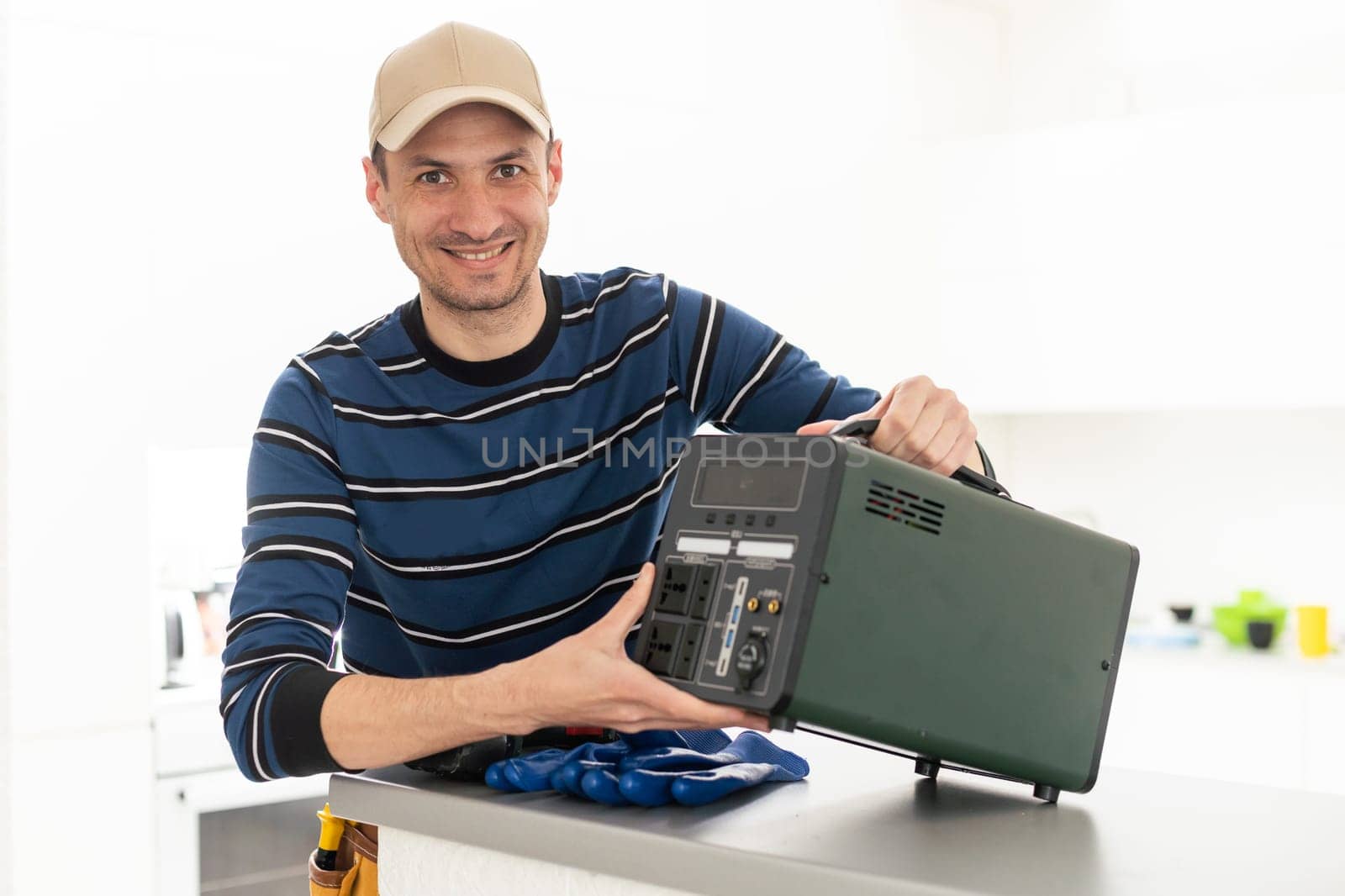 a male craftsman repairs a portable charging station.