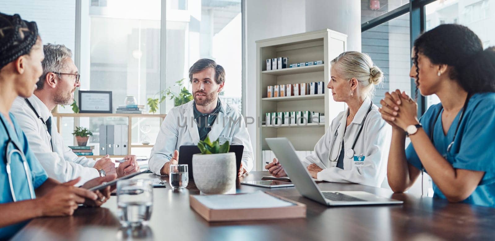 Meeting, team and doctors in discussion in the hospital conference room for collaboration. Teamwork, medical and group of healthcare workers talking about a diagnosis, strategy or treatment plan. by YuriArcurs