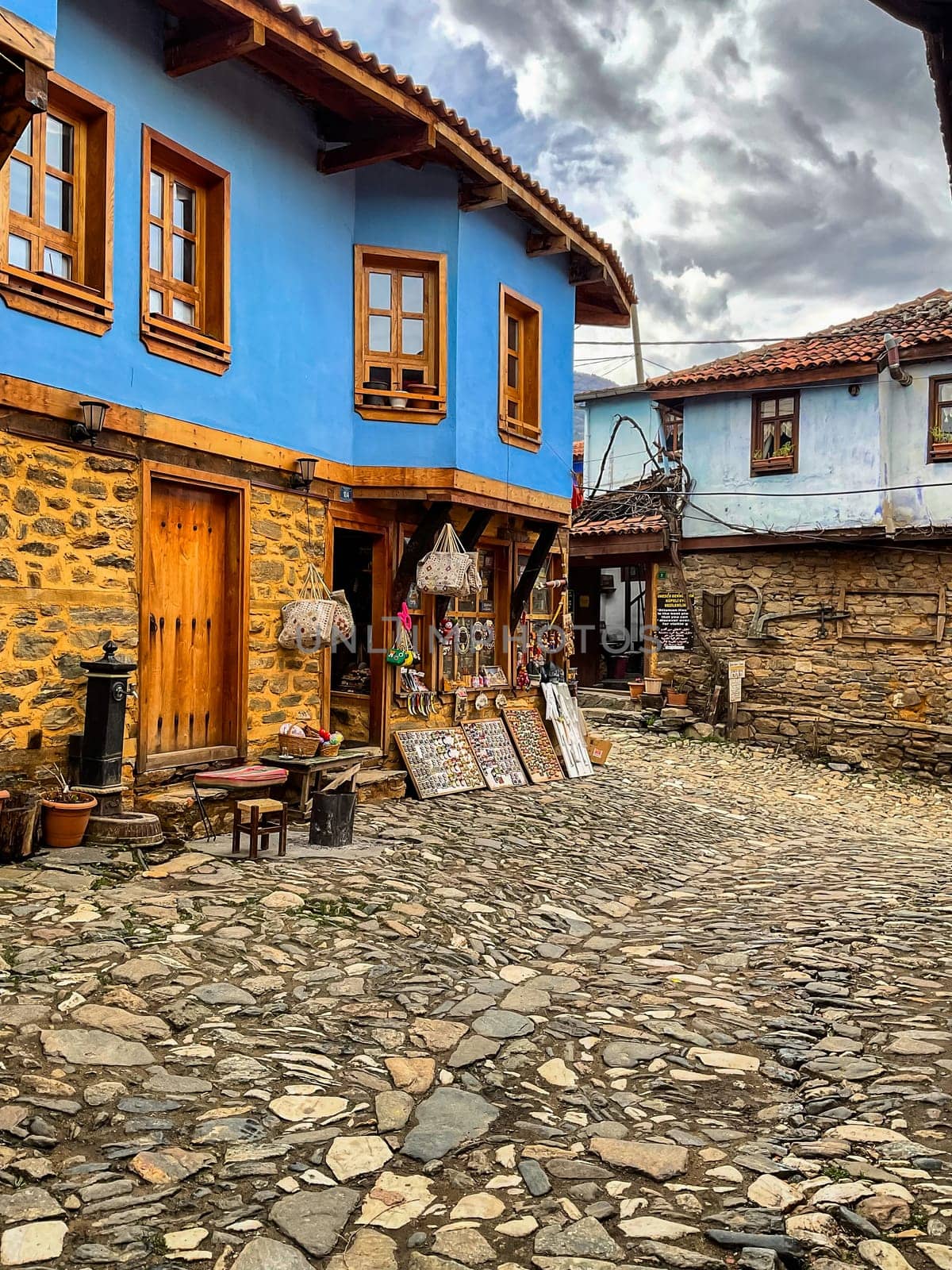 Cumalikizik village is a 700 years old Ottoman village in Turkey. Old Ottoman village in Bursa city, Turkey. Narrow street with old Ottoman houses and turkish flag