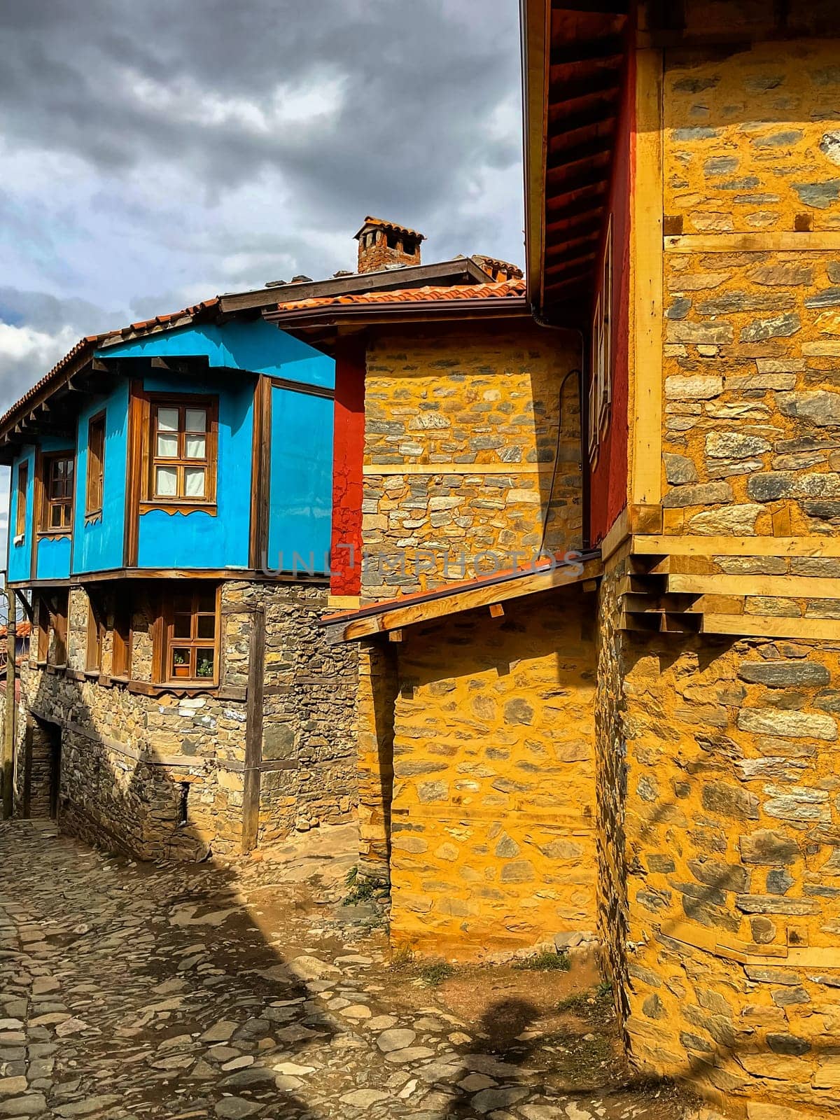 Cumalikizik village is a 700 years old Ottoman village in Turkey. Old Ottoman village in Bursa city, Turkey. Narrow street with old Ottoman houses and turkish flag