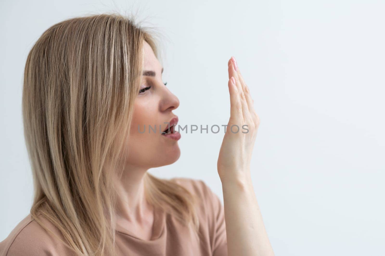 serious girl checks her mouth breath by Andelov13