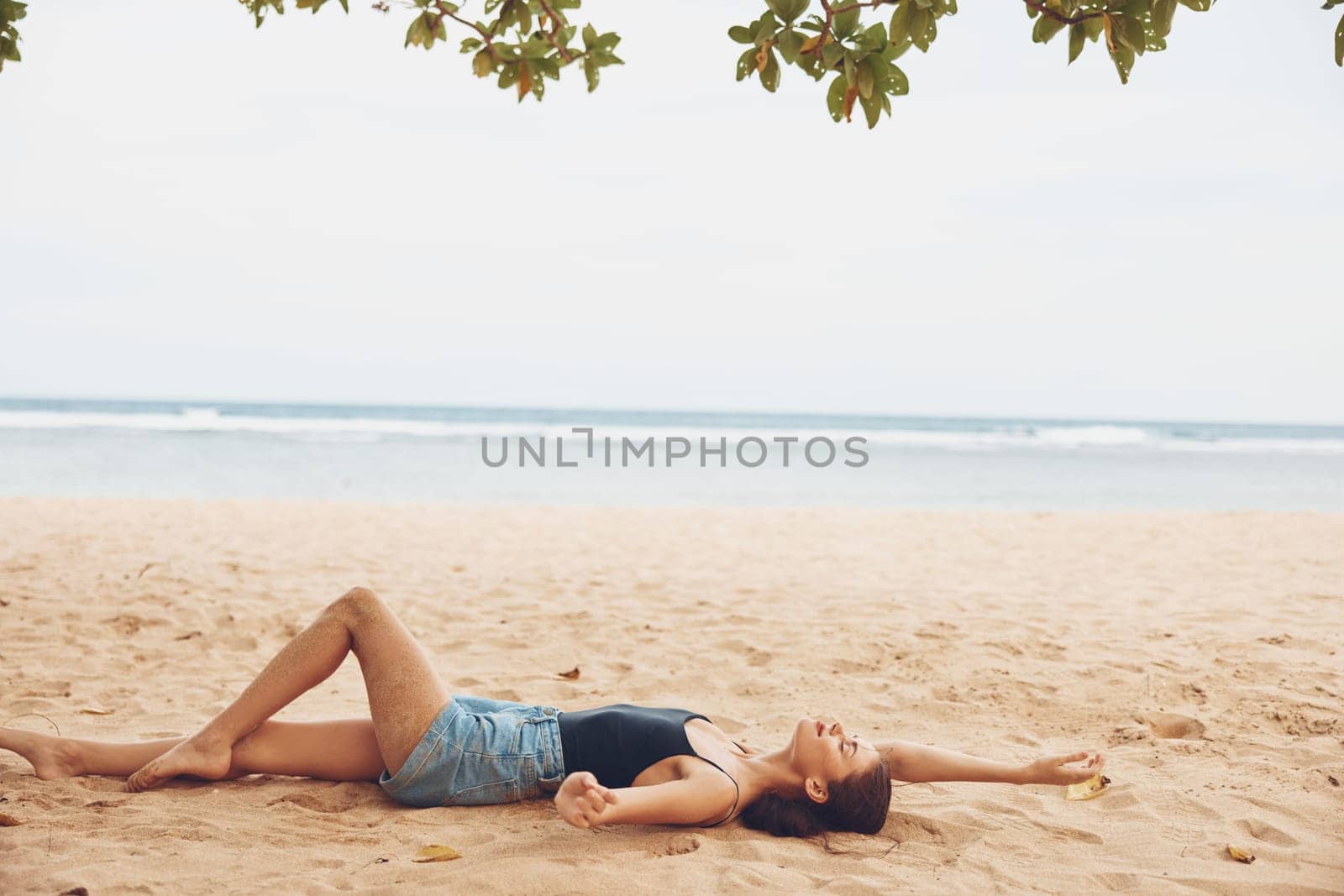 woman sand sun travel bali nature vacation alone holiday caucasian sitting beach smile female back natural freedom view sea fashion outdoor tan