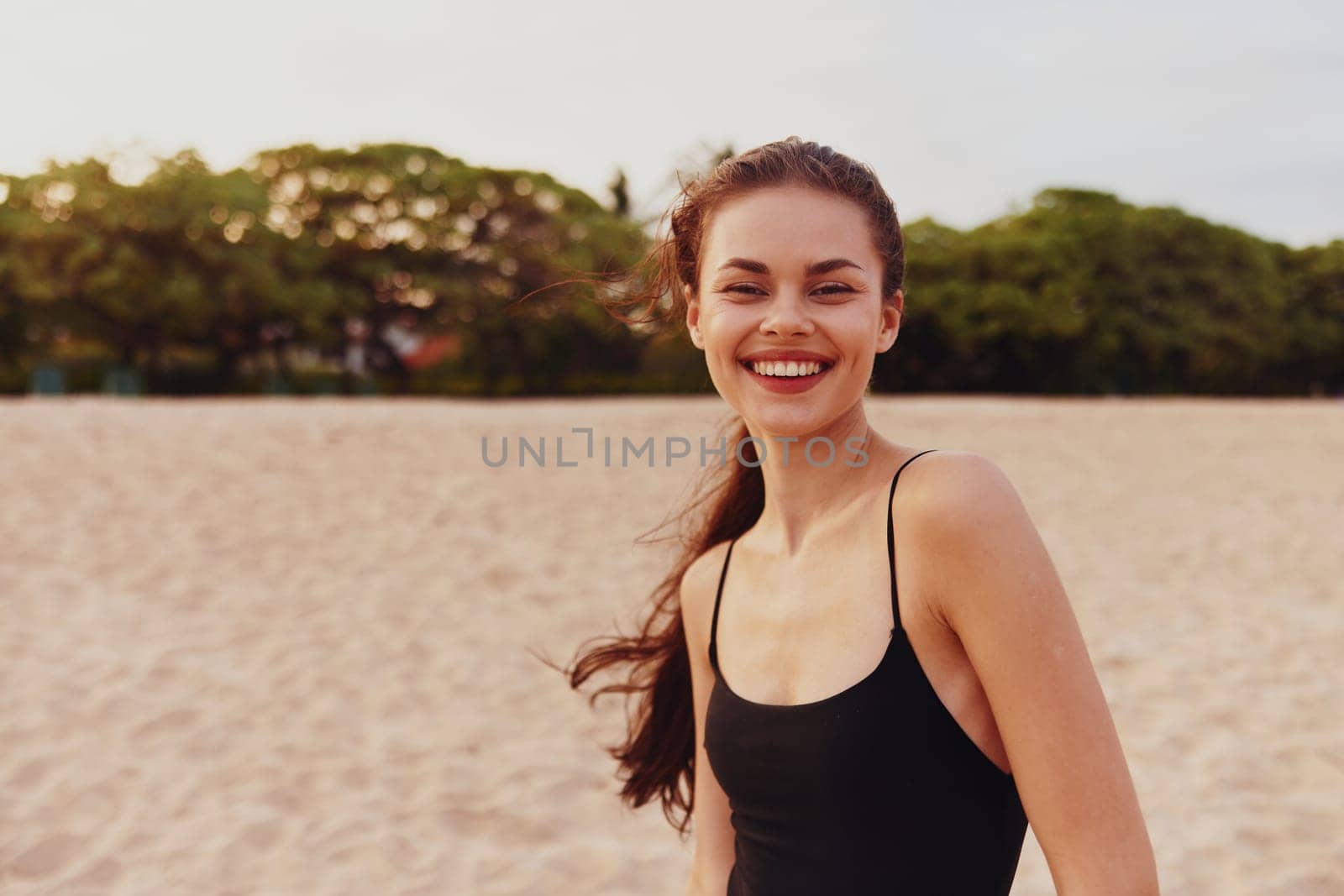 woman sand sunset tropical smiling carefree beauty relax smile lifestyle adult sky vacation ocean dress free leisure summer sea beach copy-space