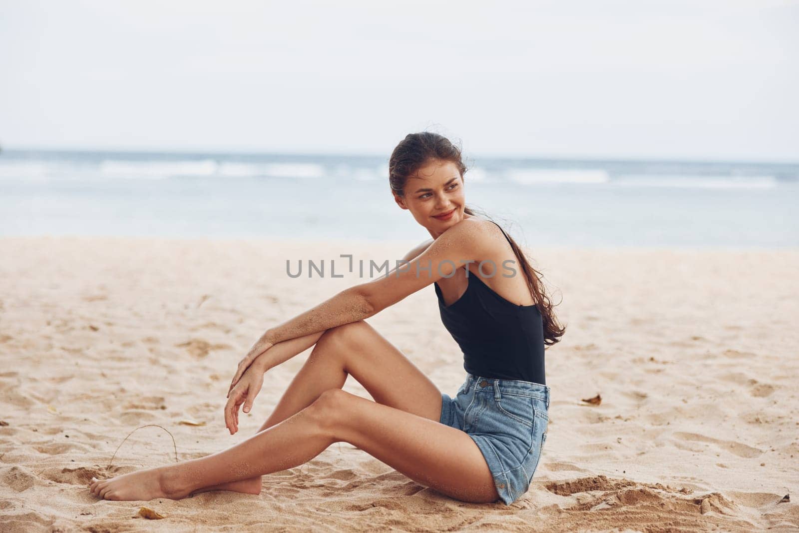 woman body smile travel fashion ocean sea hair coast sand alone sitting nature person vacation freedom outdoor beach relax lifestyle holiday