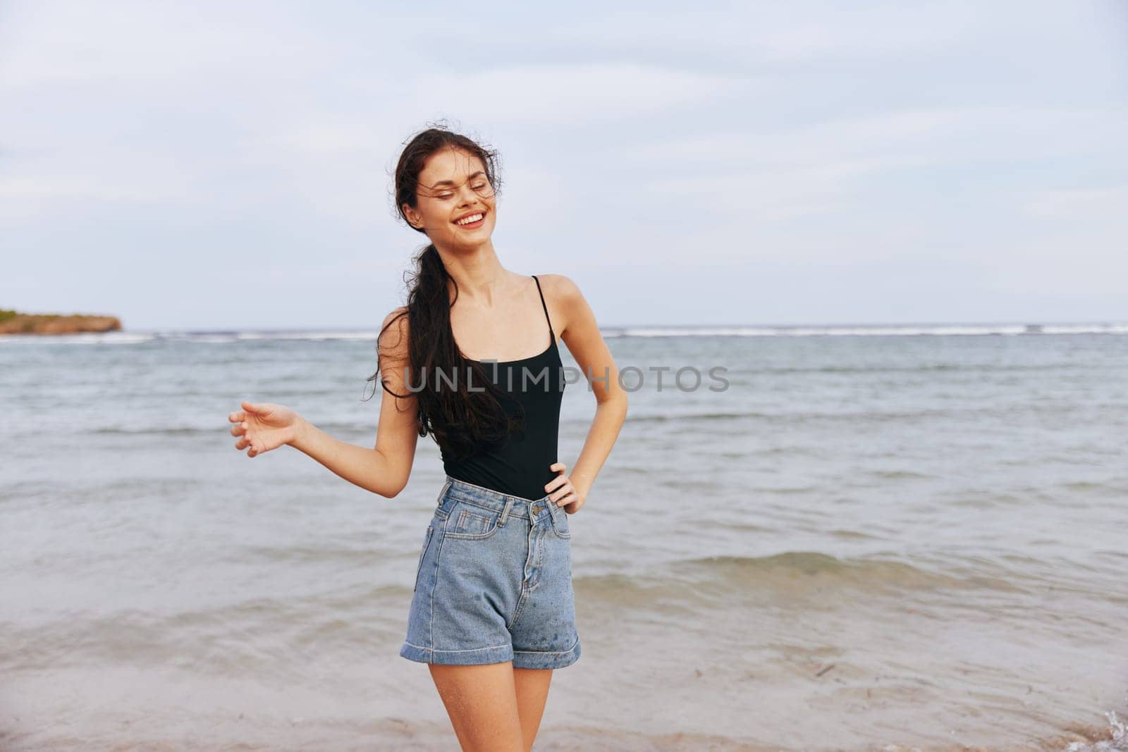 tropical woman smiling sunlight vacation holiday copy space beach sunset jean sand lifestyle summer carefree sea ocean female enjoyment adult shore smile