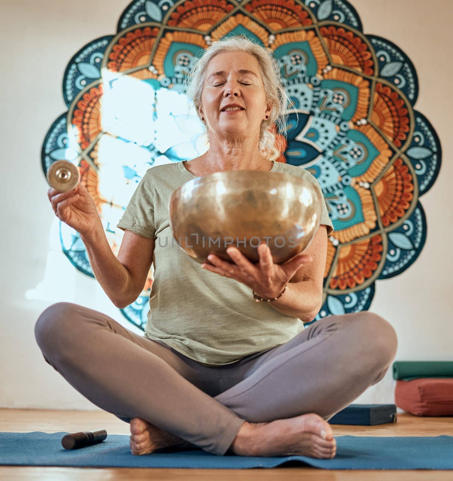 Senior woman, yoga and meditation in fitness studio for body health and wellness motivation with gold bowl and mandala. Spiritual, energy and balance with mindfulness and zen, healthy and peace