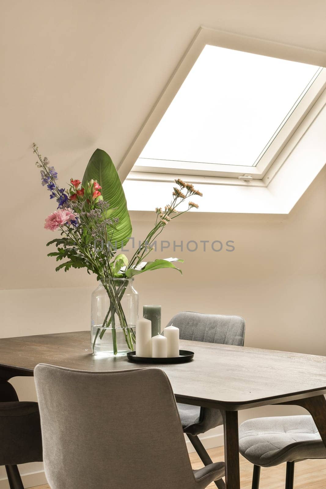 a dining room table with a vase of flowers by casamedia