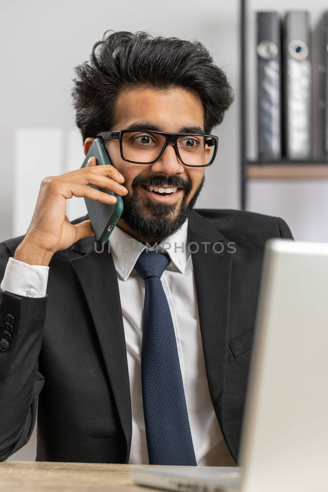 Oh my God, Wow. Happy amazed young indian businessman working on laptop shocked by sudden victory, game winning, lottery goal achievemen, good news. Bearded manager man freelancer at home office