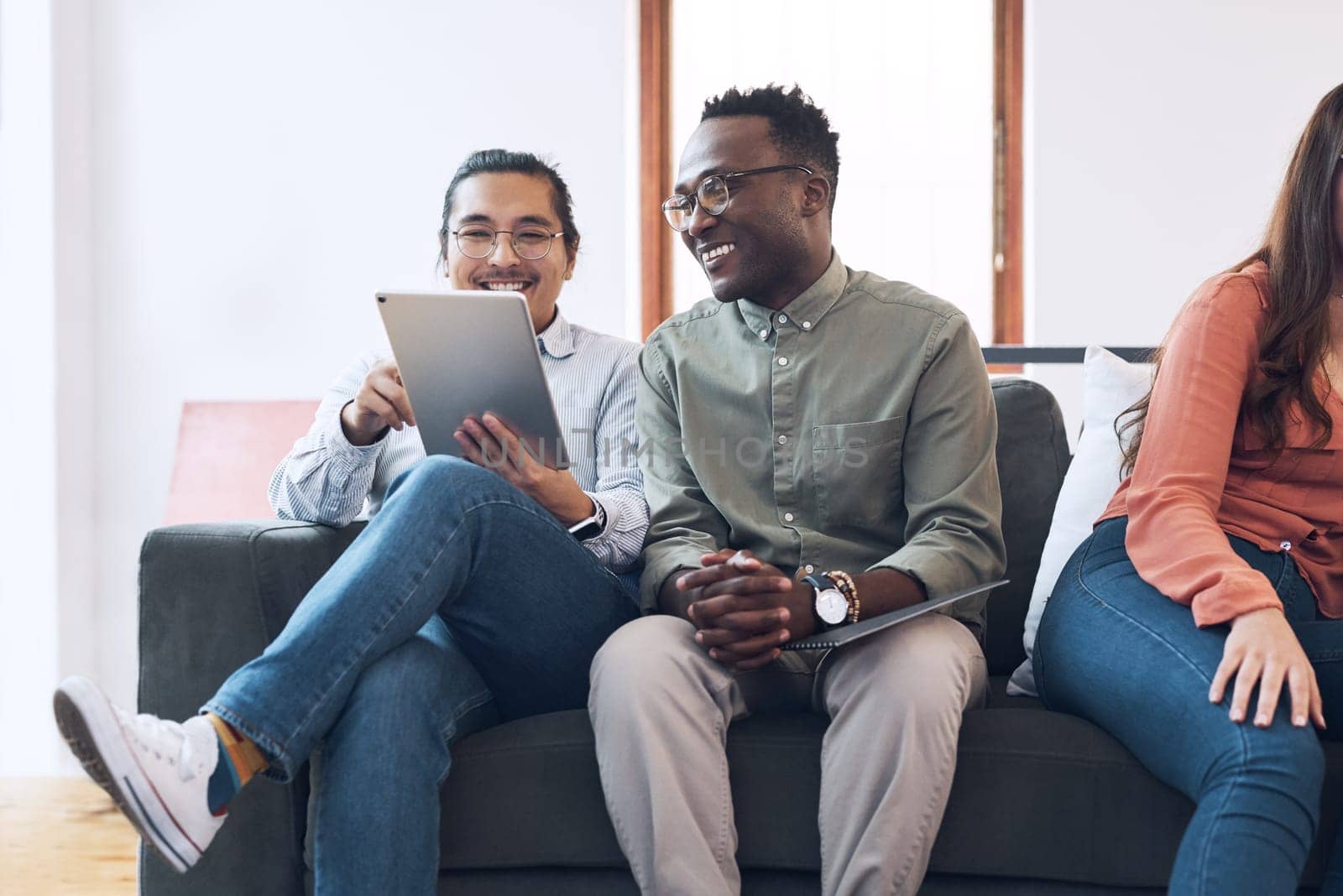 Productivity inspired by comfort. a group of young businesspeople having a meeting on a sofa in a modern office