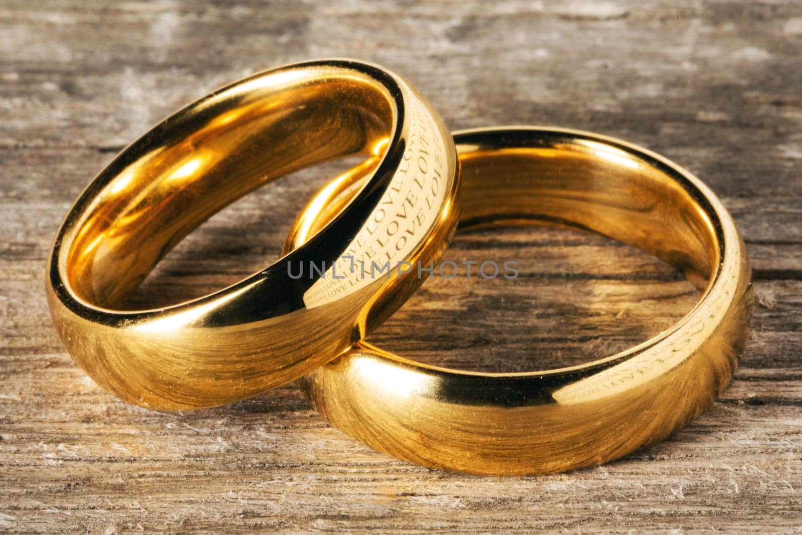 Two golden wedding rings on wooden background