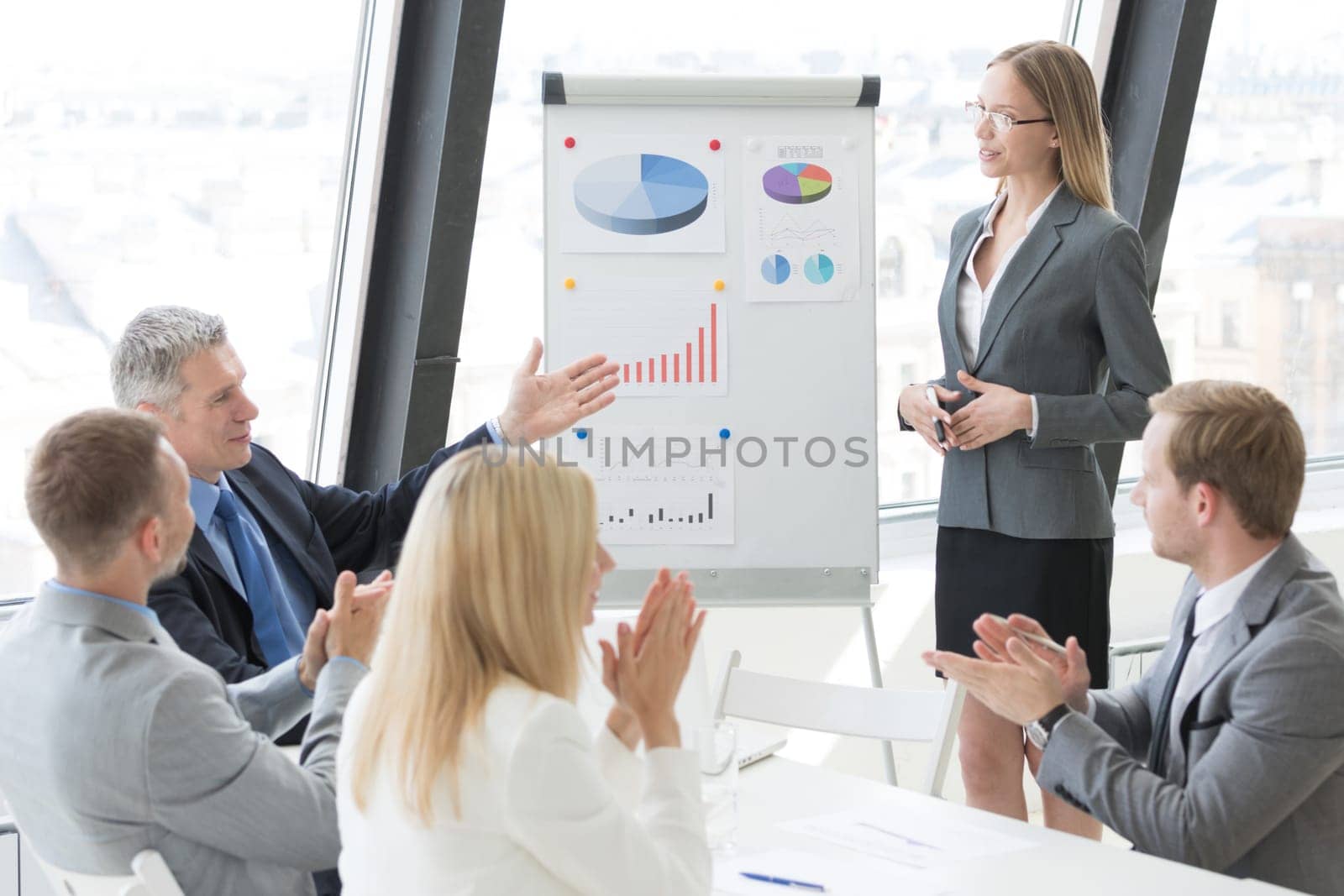 Business people team at presentation working with charts and diargams at flipchart in office