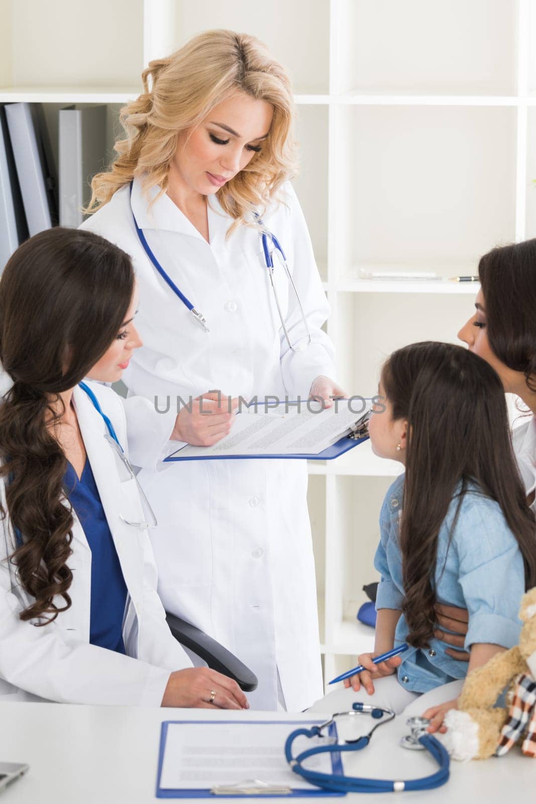 Pediatrician doctors and girl patient by Yellowj