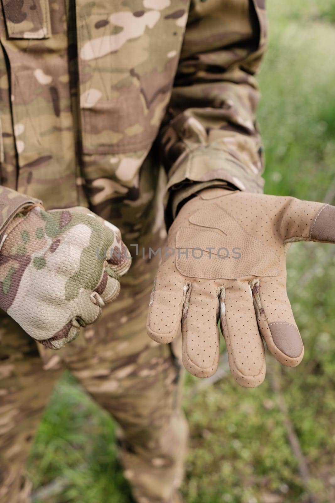 Preparing for Action: Close-up of Camouflaged Tactical Gloves being Fastened by Symonenko