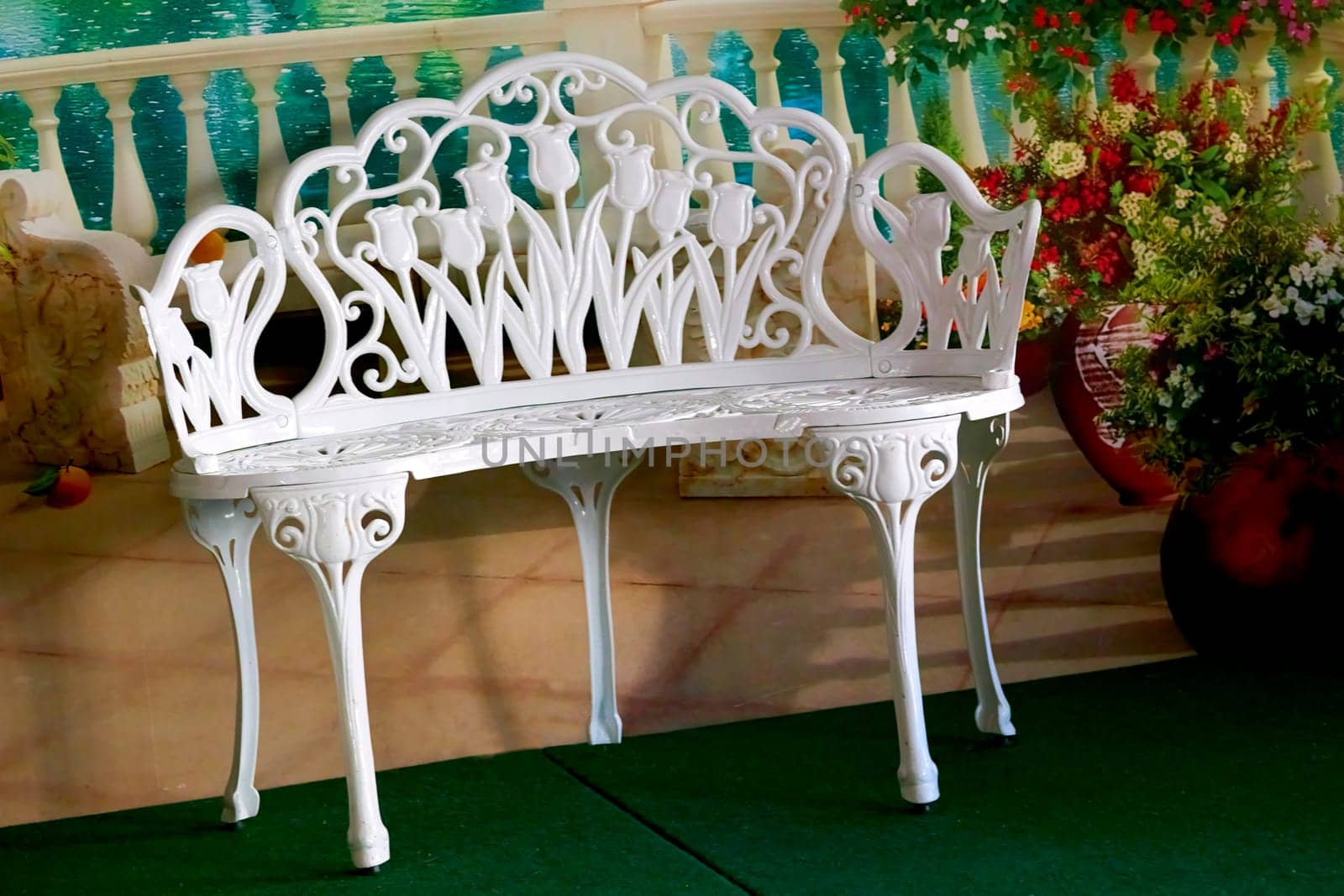 White miniature openwork carved bench in the hallway with flowers by jovani68