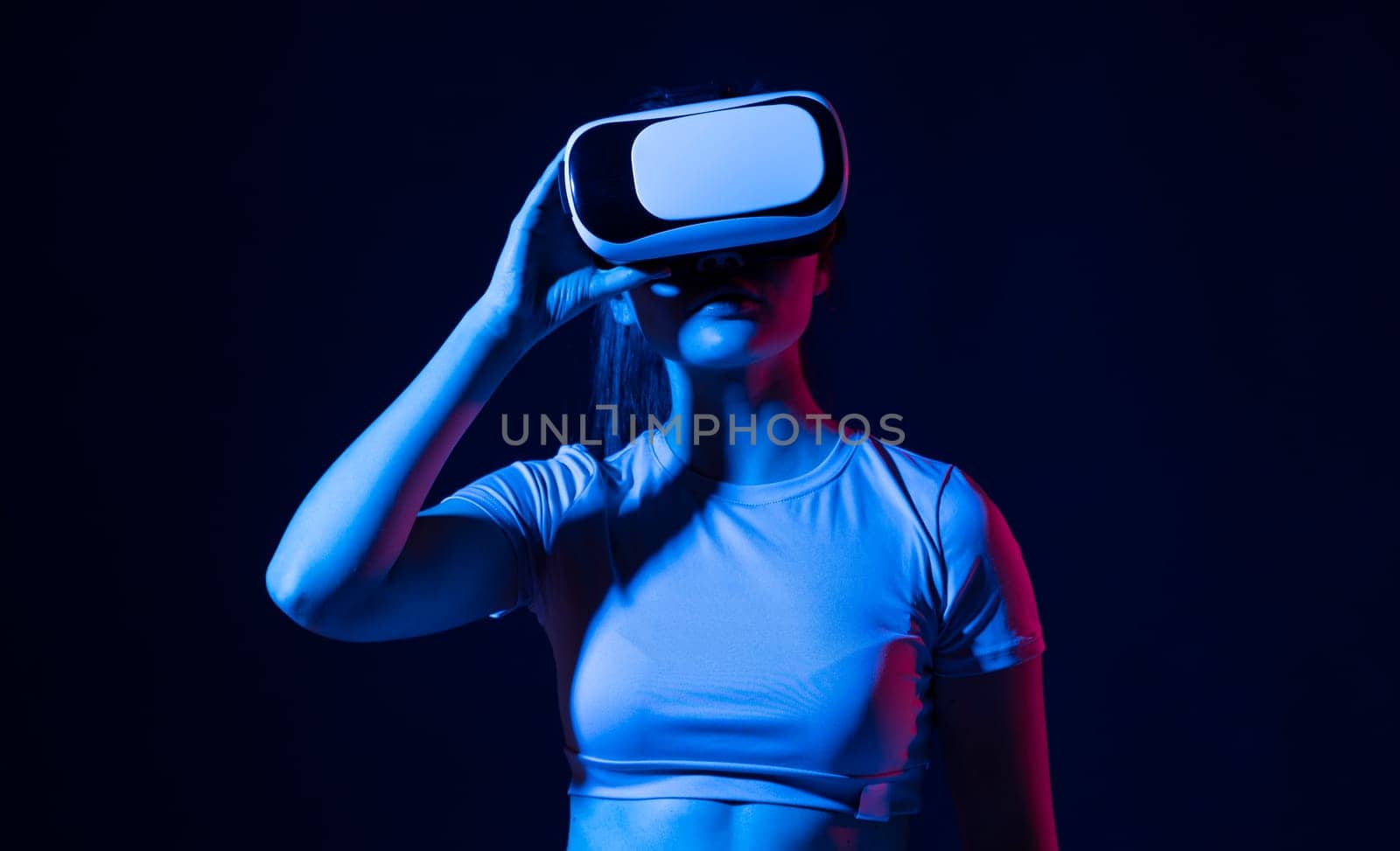 Woman using VR virtual reality glasses headset pointing at objects in metaverse. Virtual reality metaverse