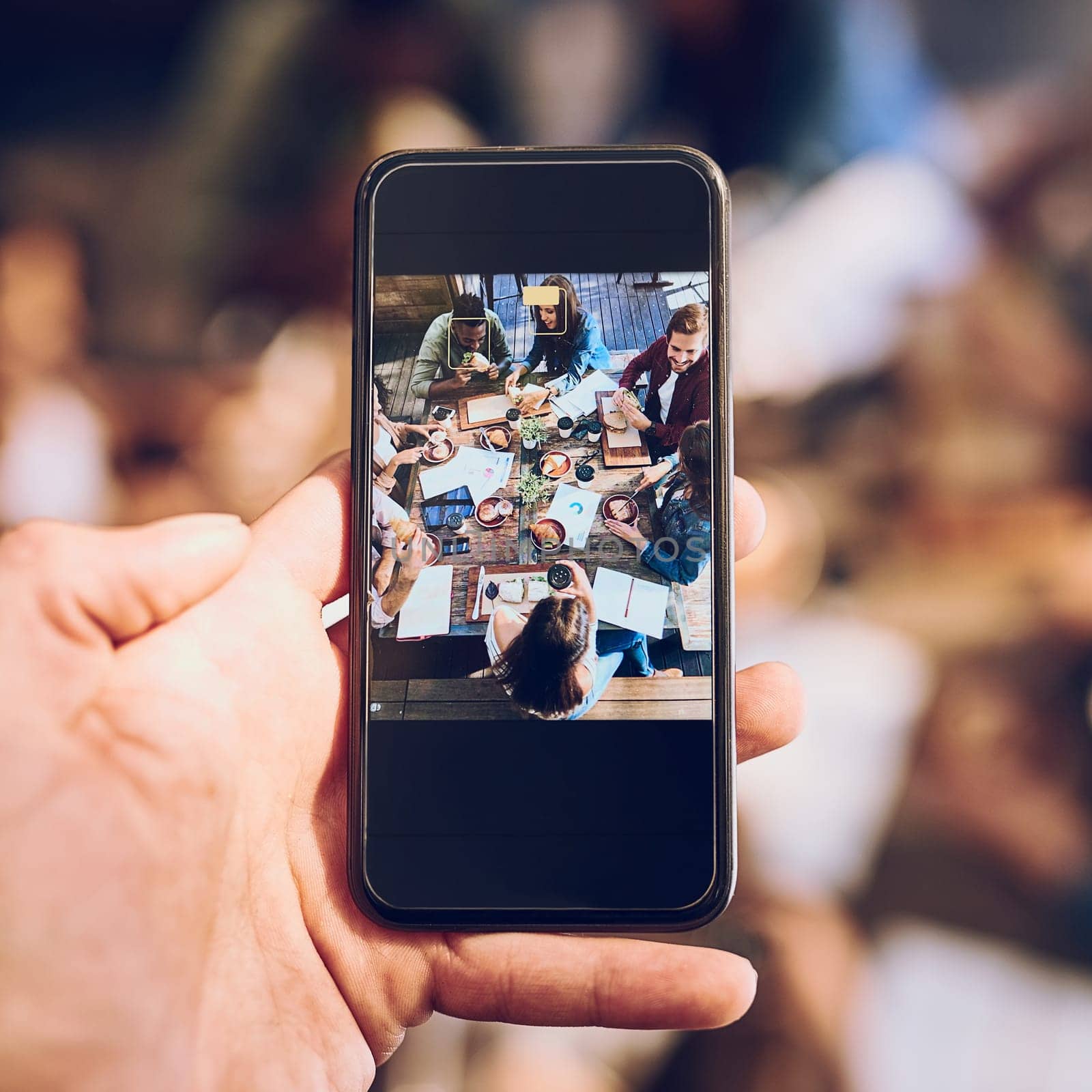 This one is going on the office wall. a man taking a picture of colleagues having a business lunch. by YuriArcurs