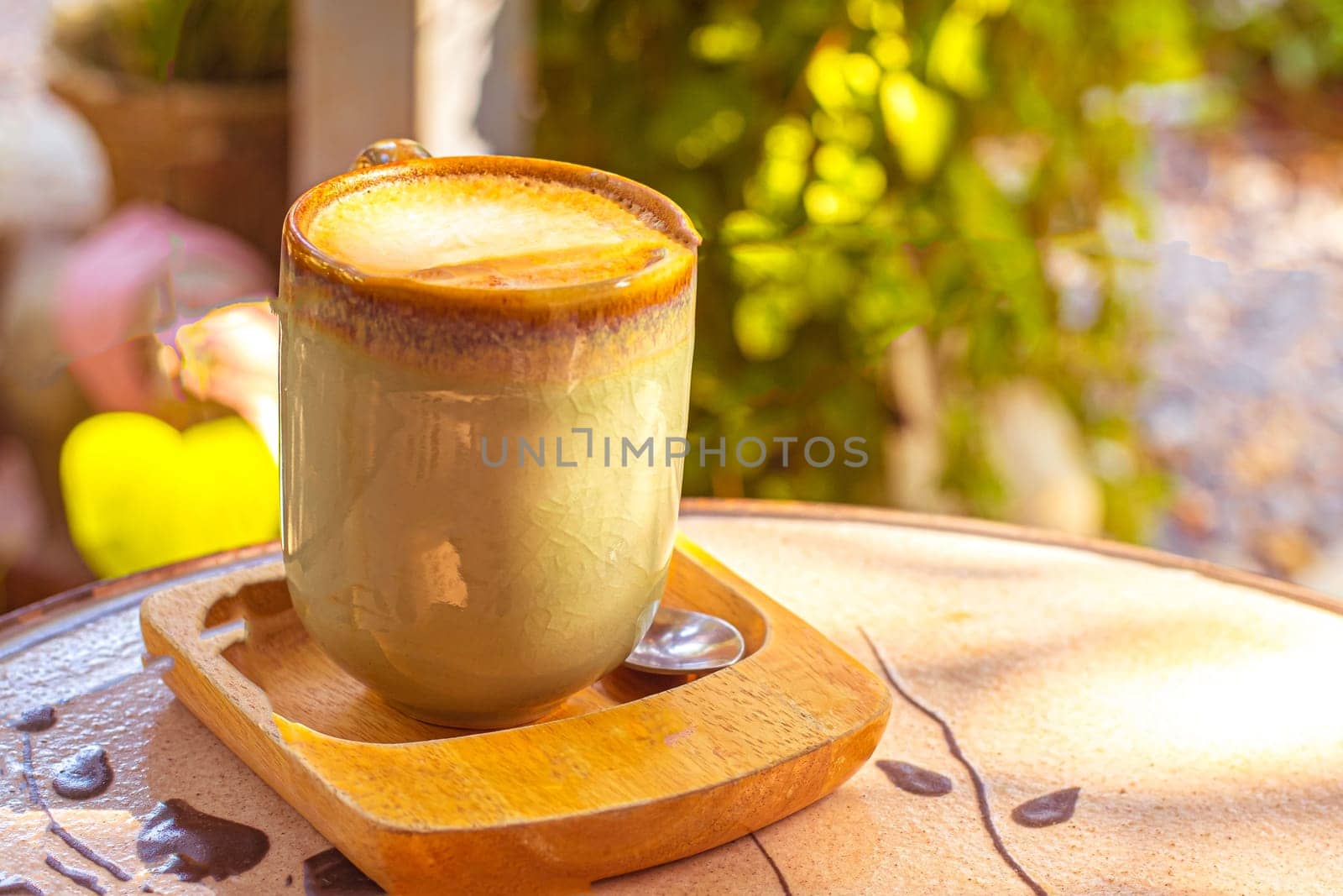 coffee, books on table in summer garden. Rest in garden, reading books, breakfast, vacations in nature concept. Summertime in garden on backyard by Petrichor