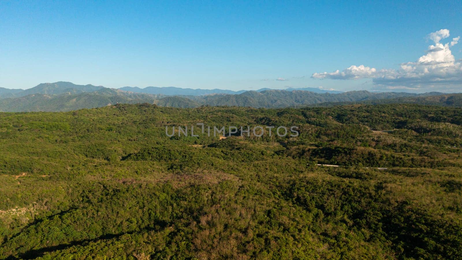 Mountain slopes covered with rainforest and jungle View from above. Philippines.