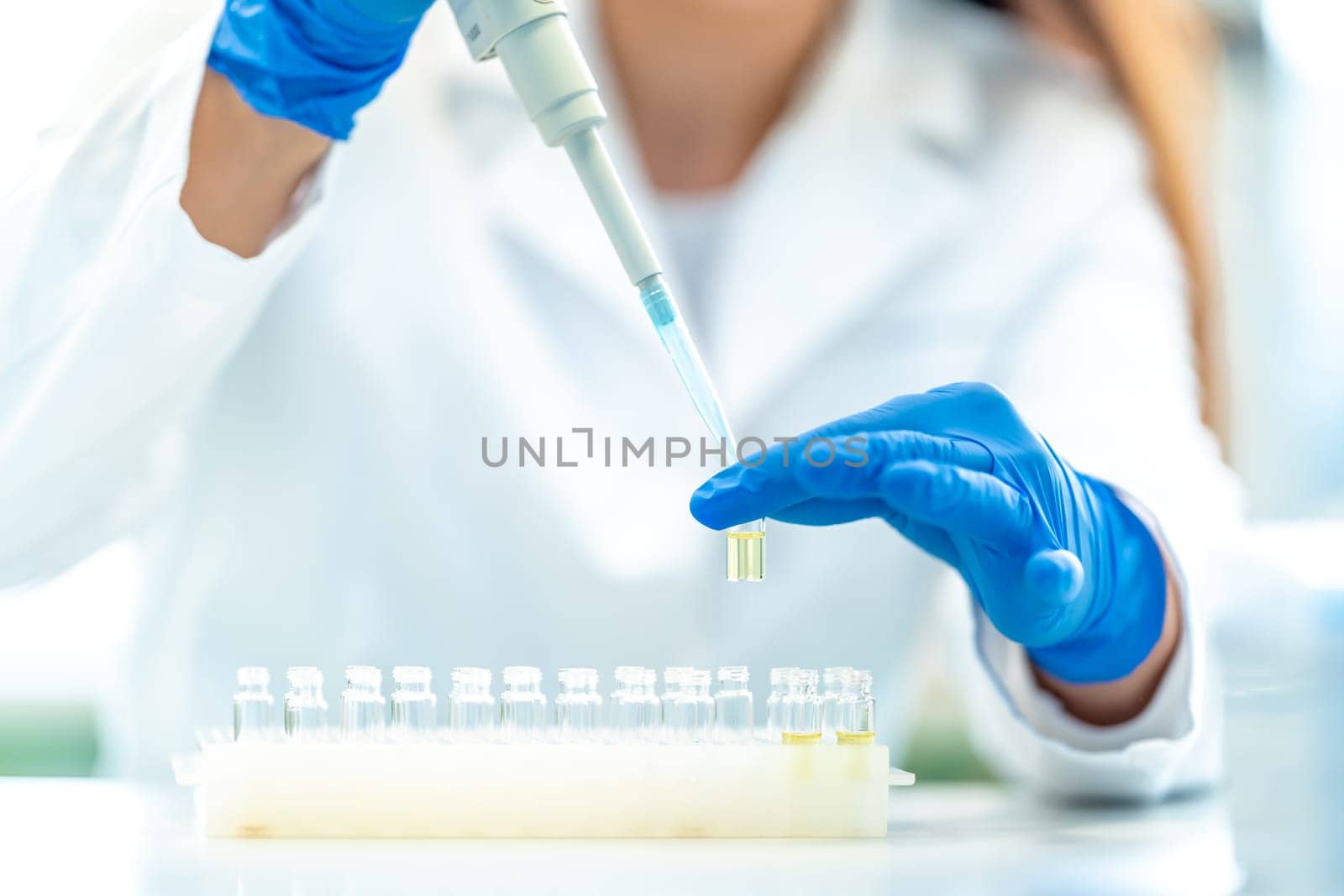 pipetting of chemical samples during research in a biochemical scientific laboratory. High quality photo