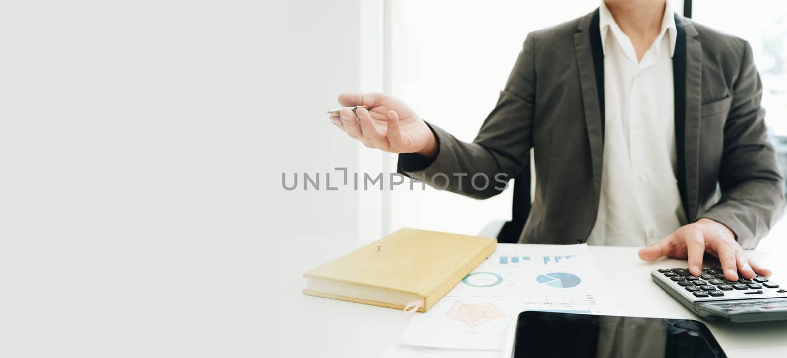 Portrait of young asian man holding notebook with presentation of strategy, investment plan and marketing. by Manastrong