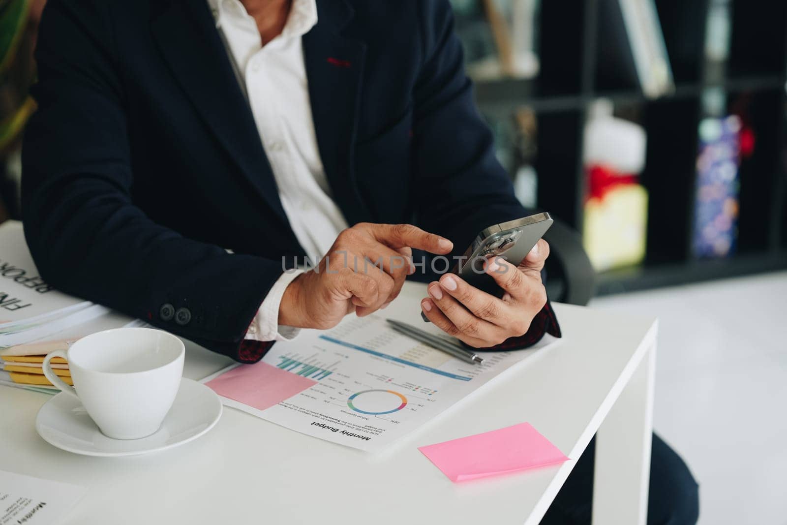 business owner or Asian male marketers are using business phones in office work.