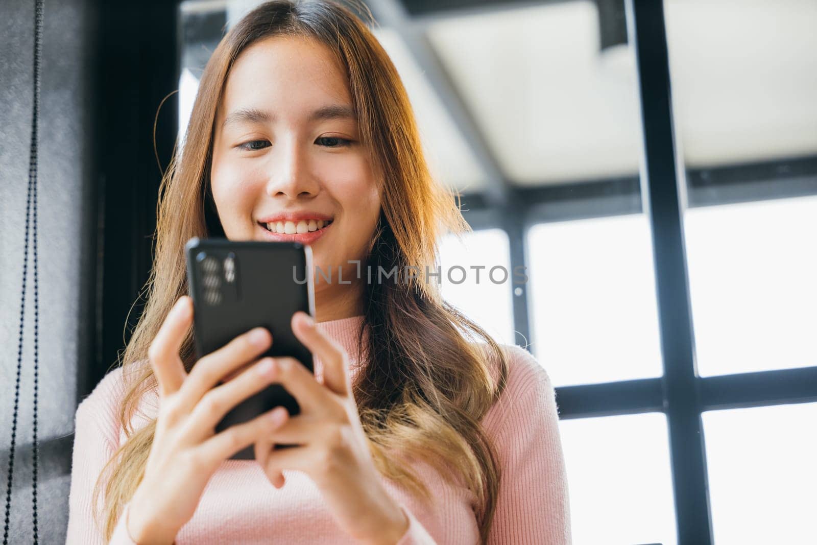 Asian young woman hands holding mobile phone at cafe coffee shop by Sorapop