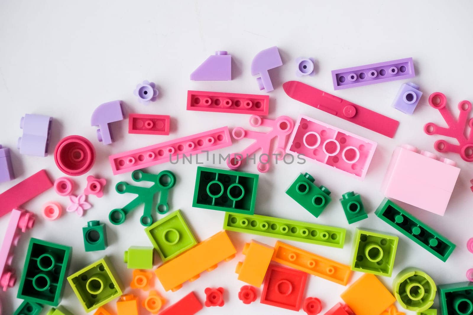 Multicolored plastic building blocks of the designer. Background of bright plastic building blocks.
