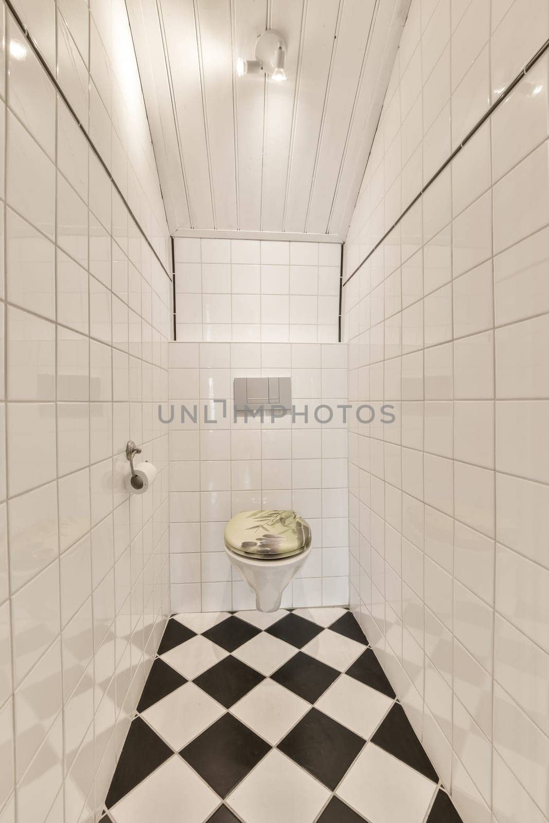 a tiled bathroom with black and white tiles on the floor, along with an open toilet in the center of the room