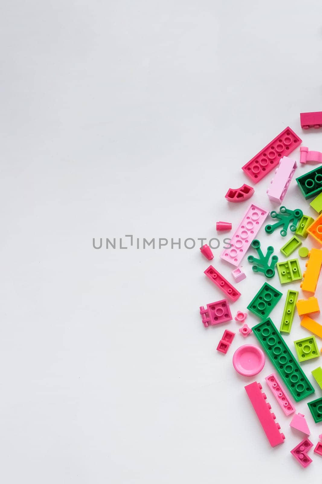 Baby kids toys background. Top view to wooden toy train, wood stacking pyramid tower and colorful wood bricks on white background. Early education, zero waste, Montessori toys for children