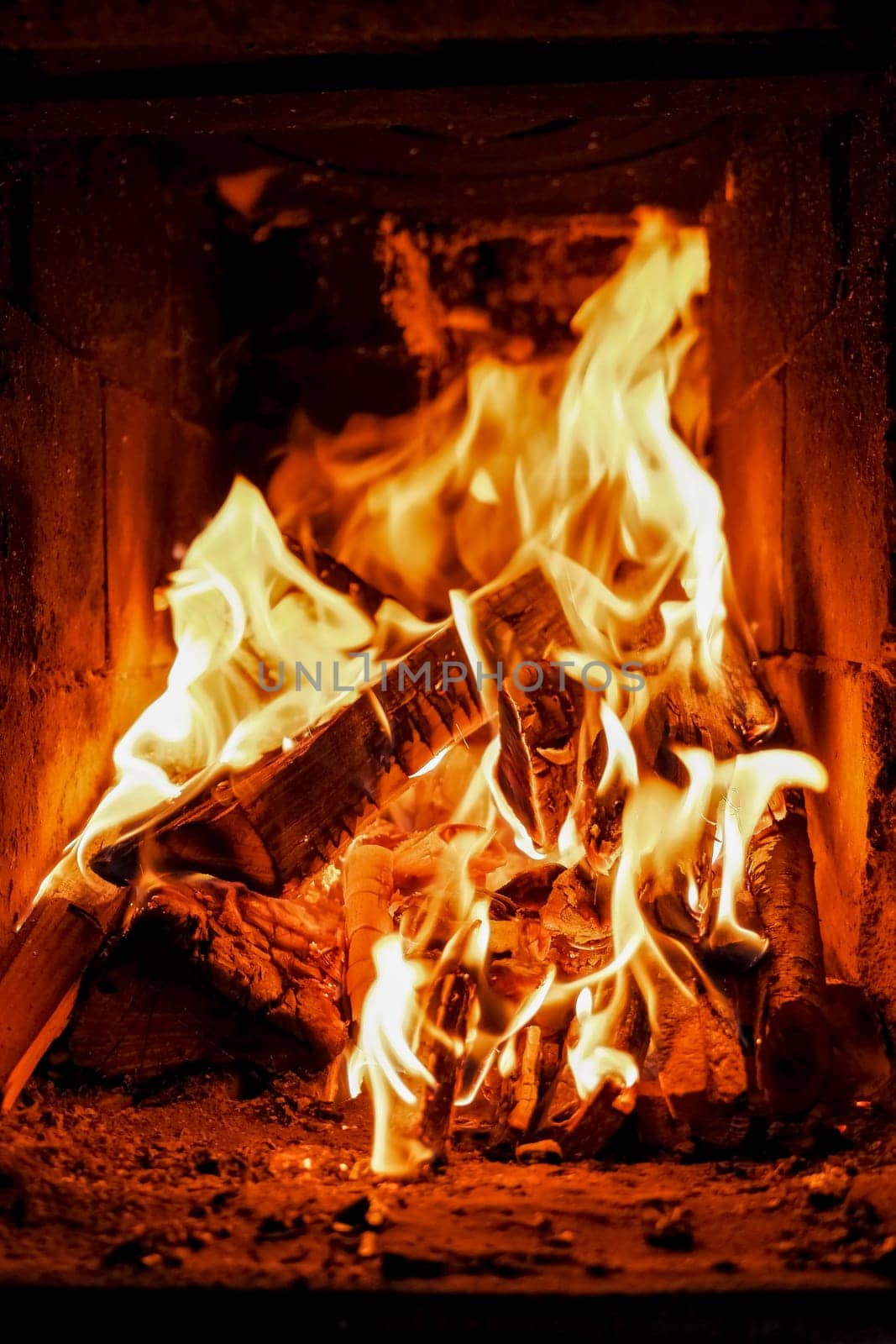 three burning billets in hot stove.Fire flame burning coal and wood in fireplace