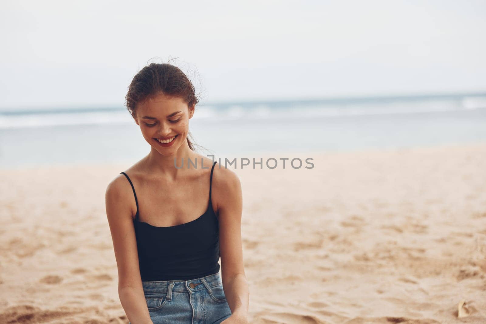 woman travel beautiful smile outdoor tropical water freedom vacation sand sea nature beach attractive sitting view ocean back holiday alone hair summer
