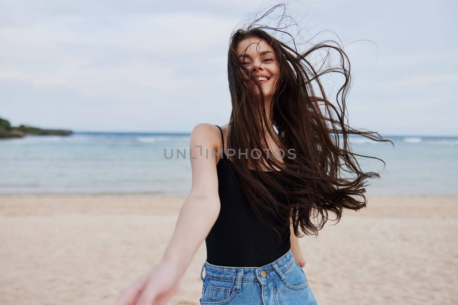 woman hair beach vacation young freedom summer active activity wave running flight female sunset lifestyle smile walking travel sea beautiful person