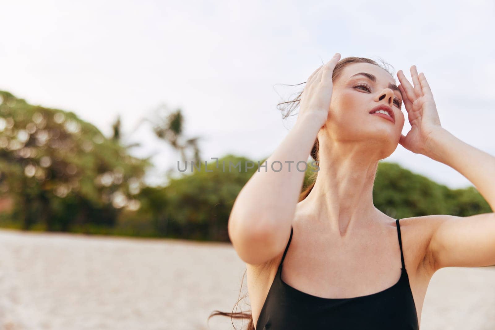 sea woman carefree lifestyle relax vacation sand beach walking peaceful ocean summer copy-space smiling adult sunset shore female smile travel freedom