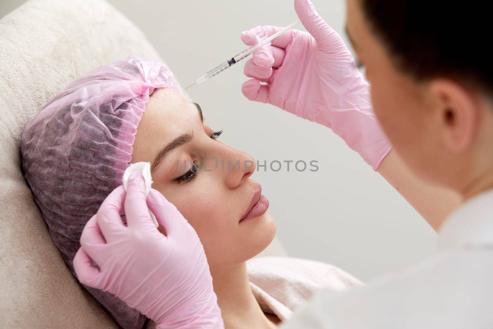 Cosmetologist performs the lift procedure by injecting beauty injections. Doctor injecting hyaluronic acid as facial rejuvenation treatment by Mariakray