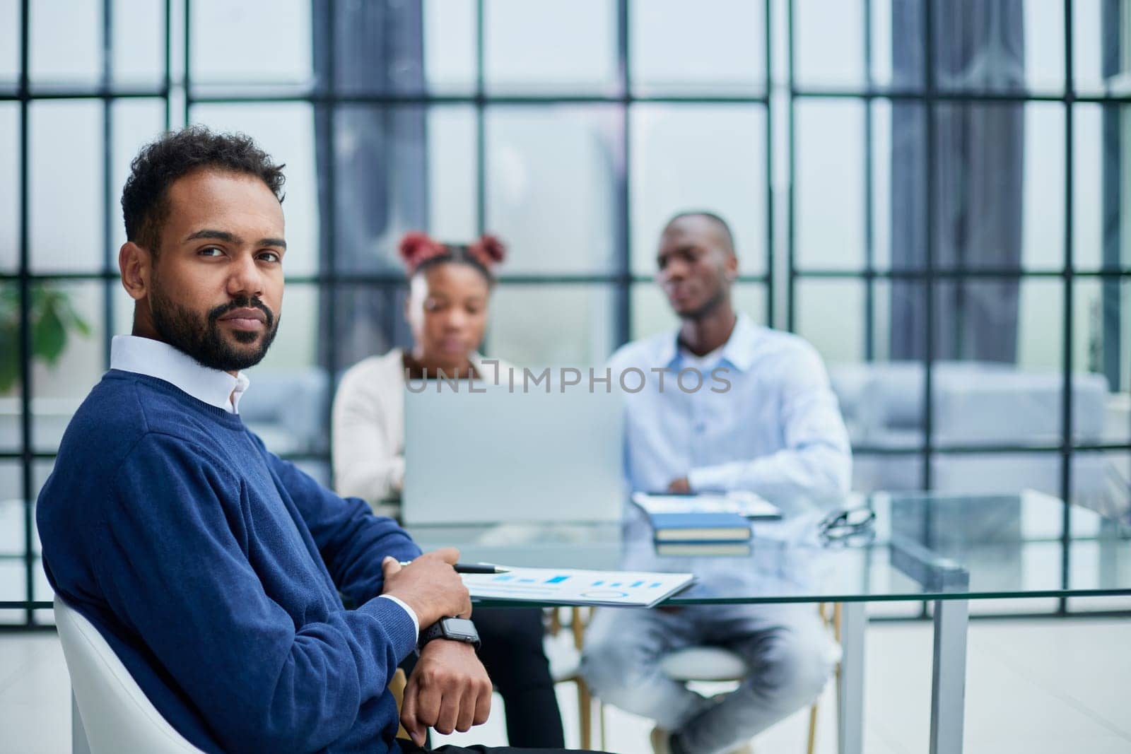 Portrait of African American businessman sitting at desk in an office