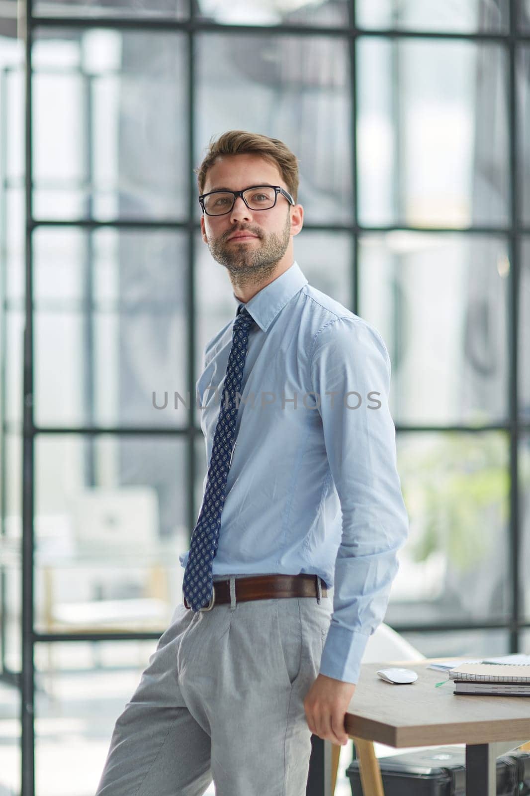 Young cheerful businessman working at office