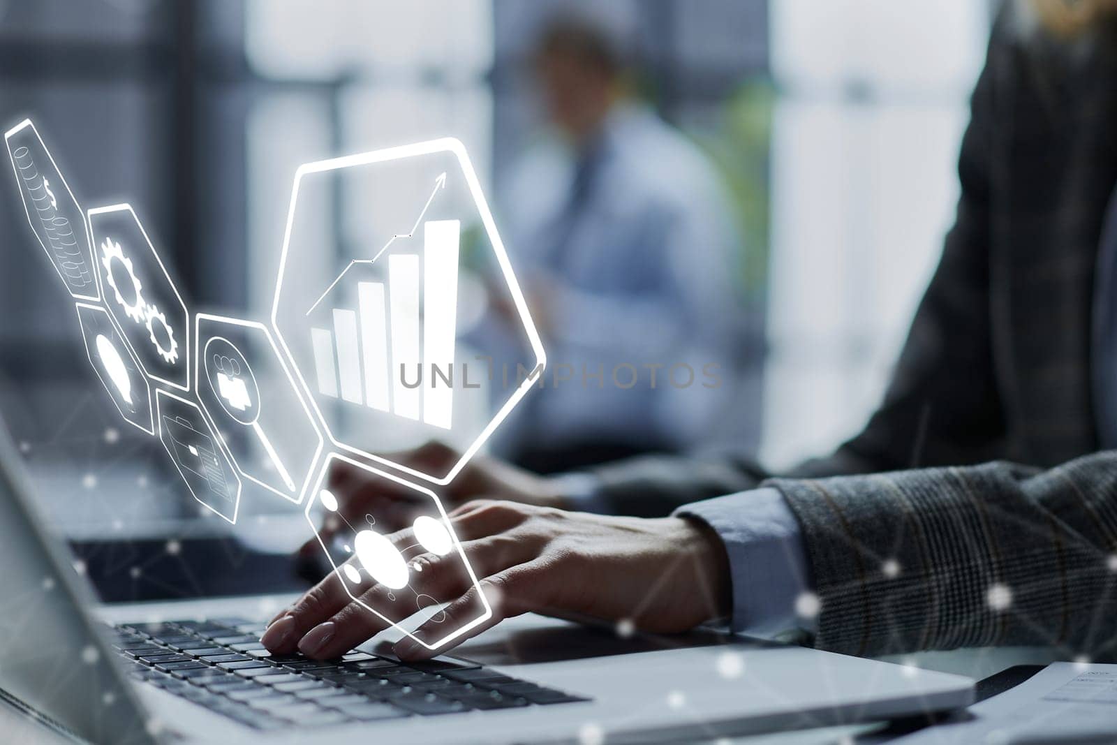 man's hands typing on laptop keyboard in interior