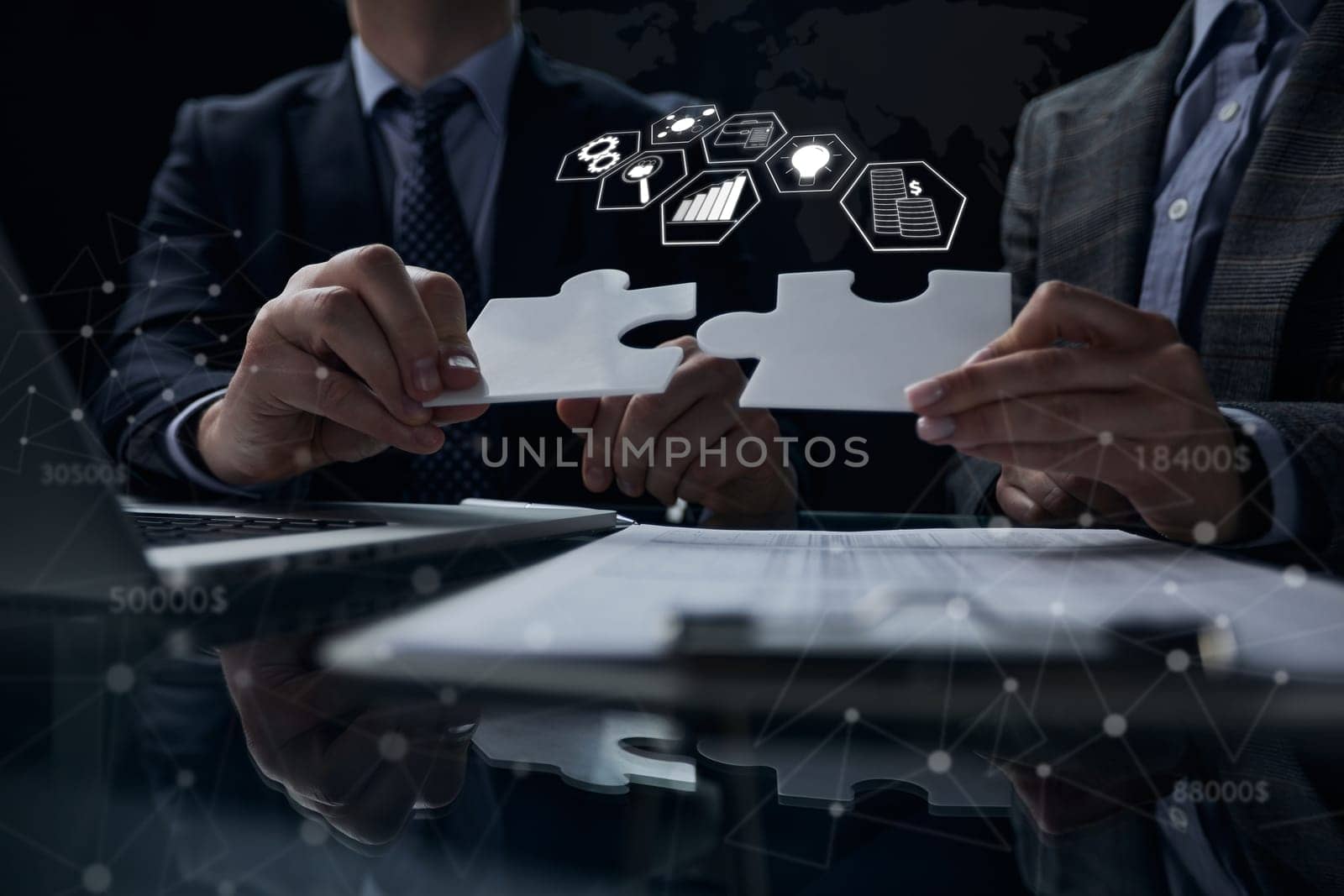 two businessmen holding two jigsaw puzzle pieces connecting a pair of puzzle pieces for matching goals, success and starting a new project in the office. Business concept.