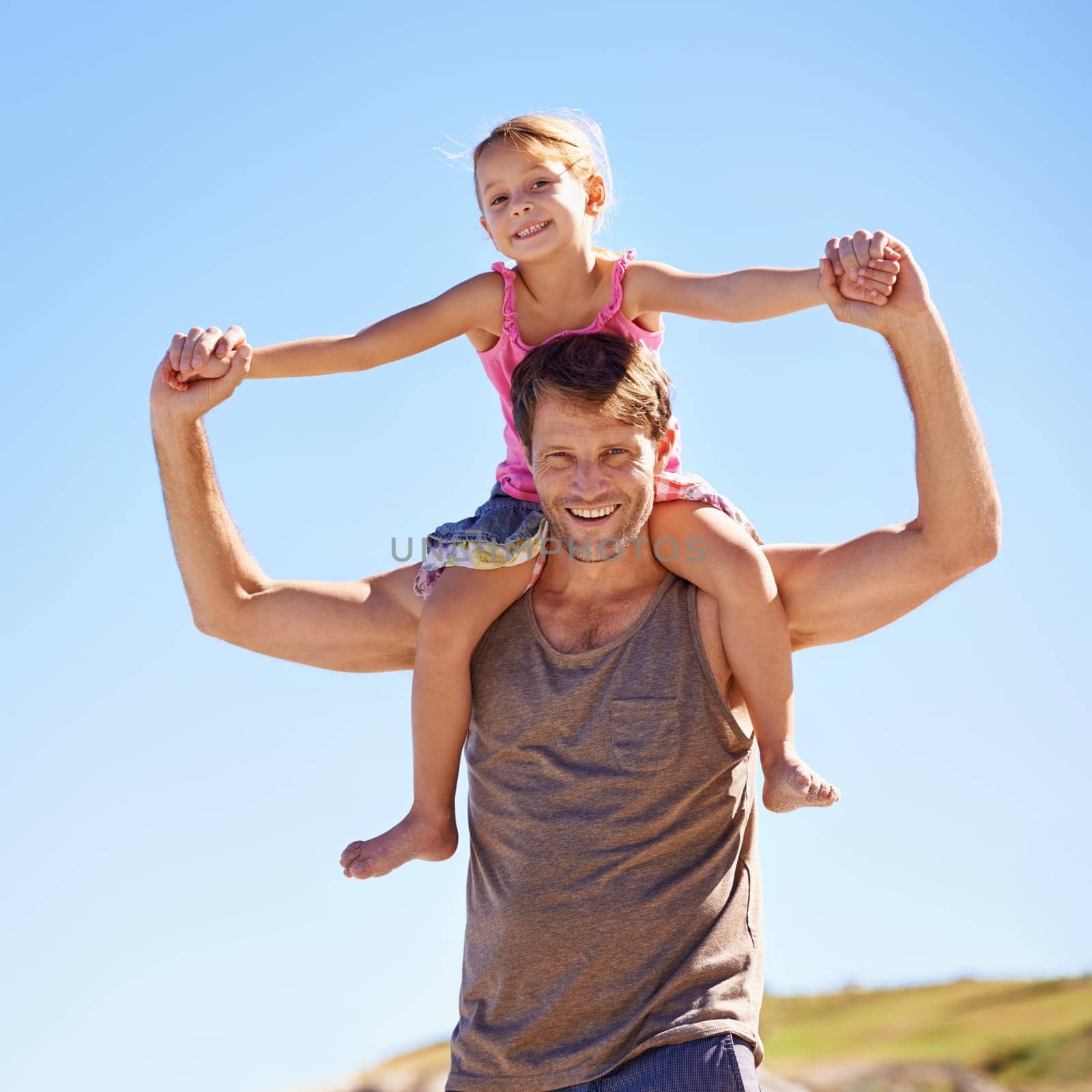 Shes on top of the world. Portrait of a handsome man giving his daughter a piggyback ride in the outdoors