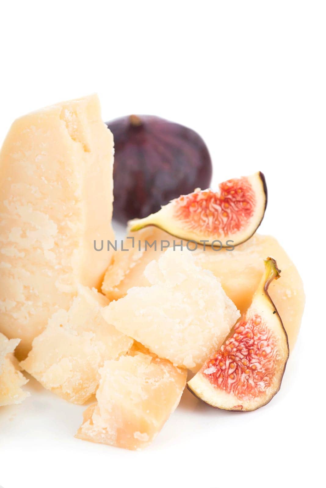 Parmesan cheese and blue figs isolated on a white backgroun. View from above