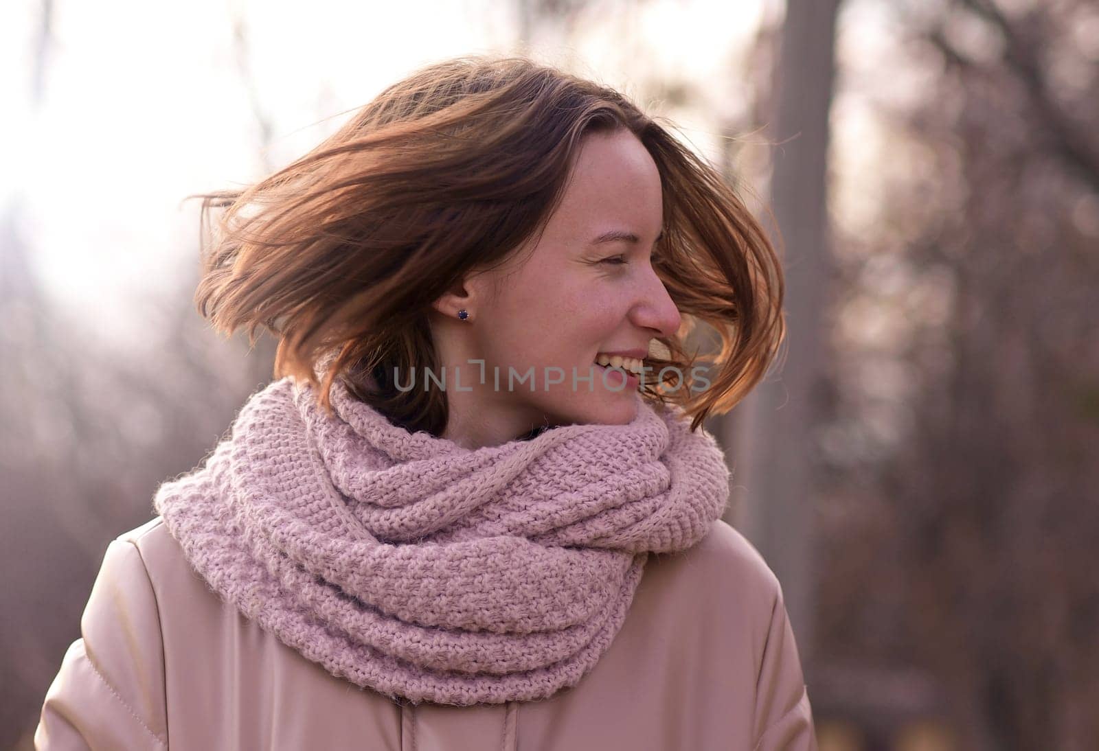 candid attractive young smiling woman walking in park, happy mood, fashion style trend, pink jacket, waving brown hair