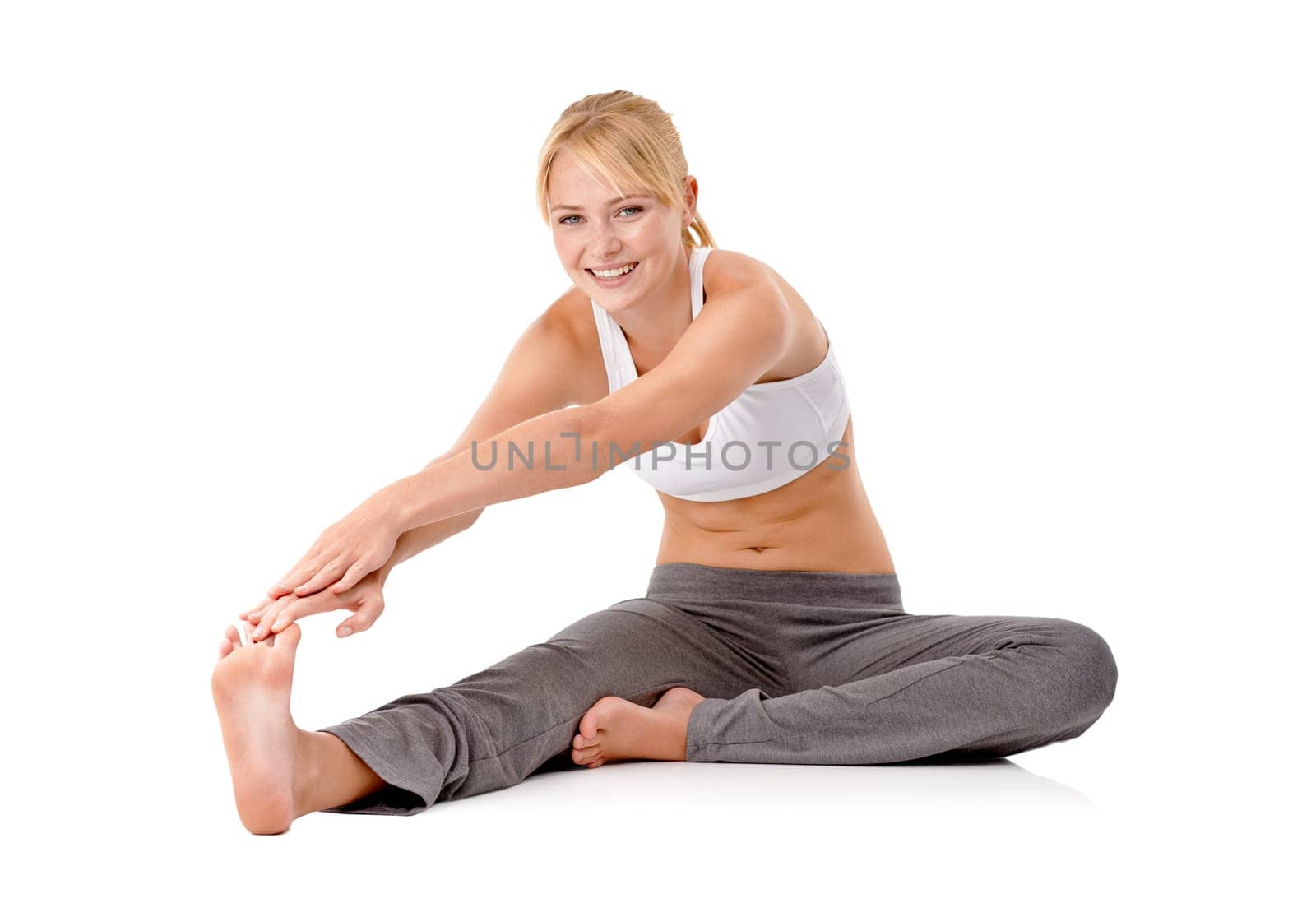 Staying fit and healthy. Full length shot of a young woman exercising on the floor isolated on white