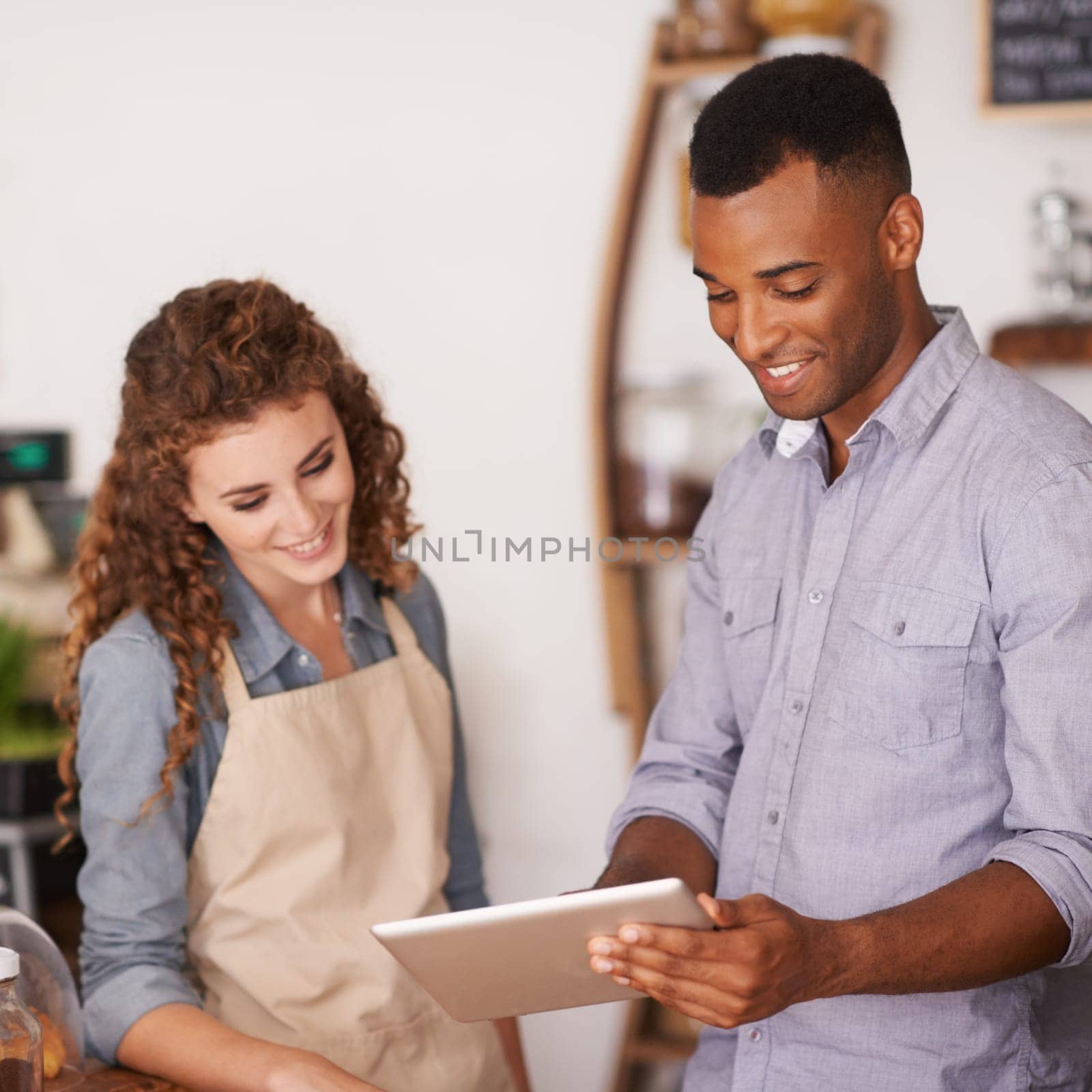Tablet, restaurant owner and teamwork of people talking, discussion and manage orders. Waiters, black man and happy woman in cafe with technology for inventory, stock check or managing sales in store.