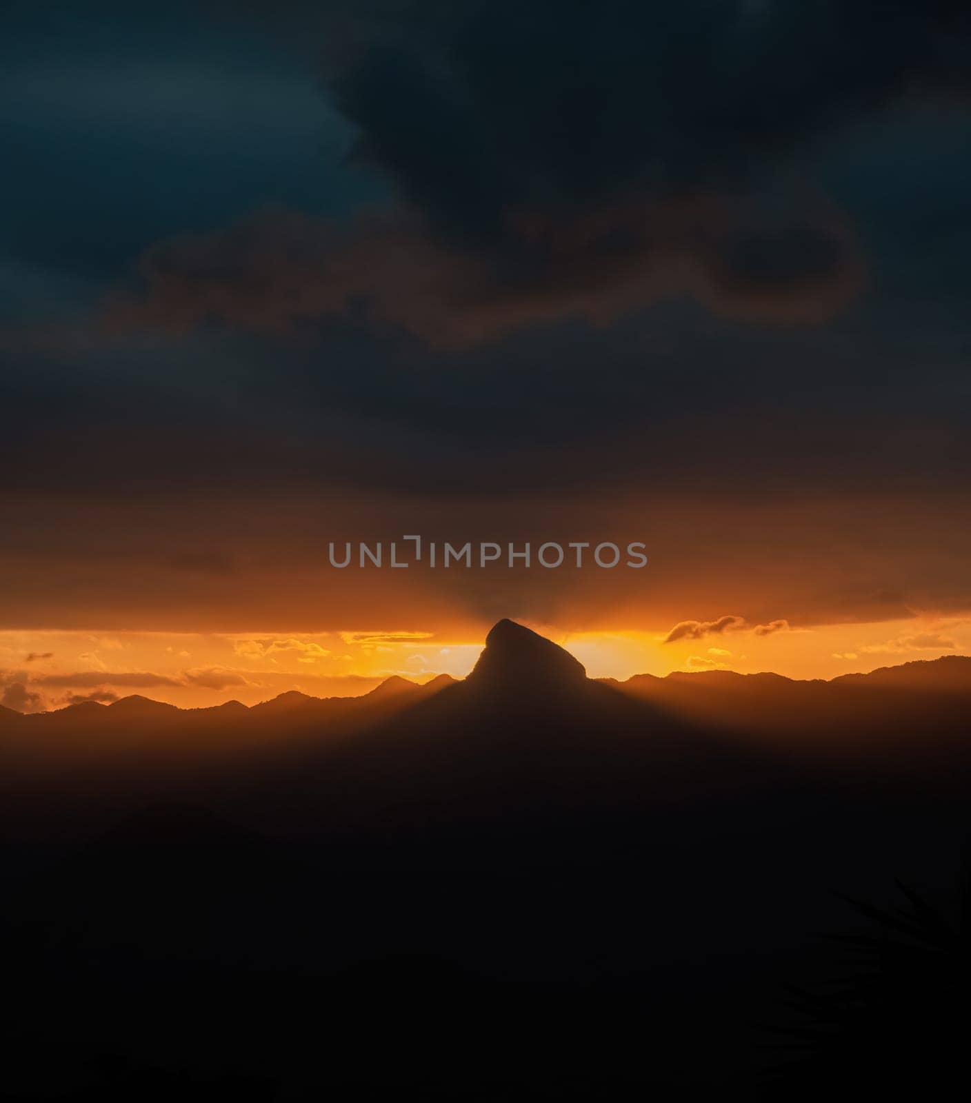 Impressive orange horizon with storm clouds, rays of light and space for text